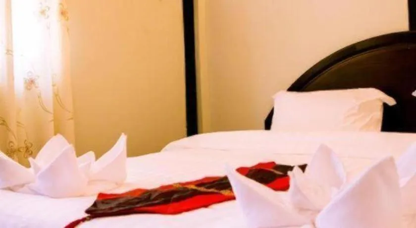 Bed in New Lao Paris Hotel