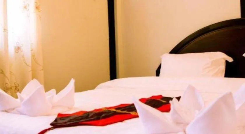 Bed in New Lao Paris Hotel