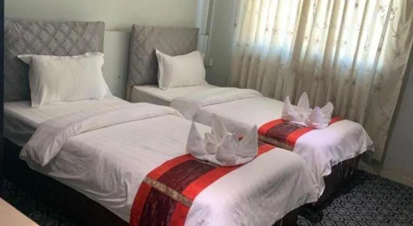 Bed in New Lao Paris Hotel