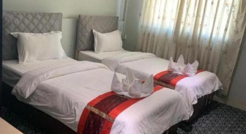 Bed in New Lao Paris Hotel