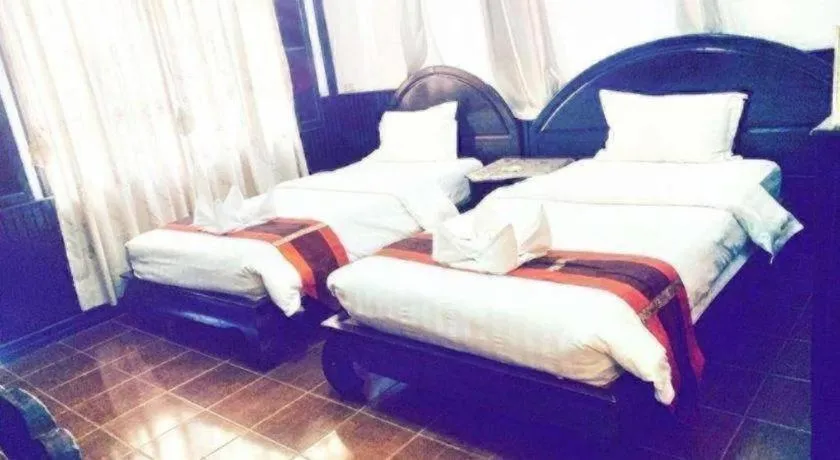 Bed in New Lao Paris Hotel