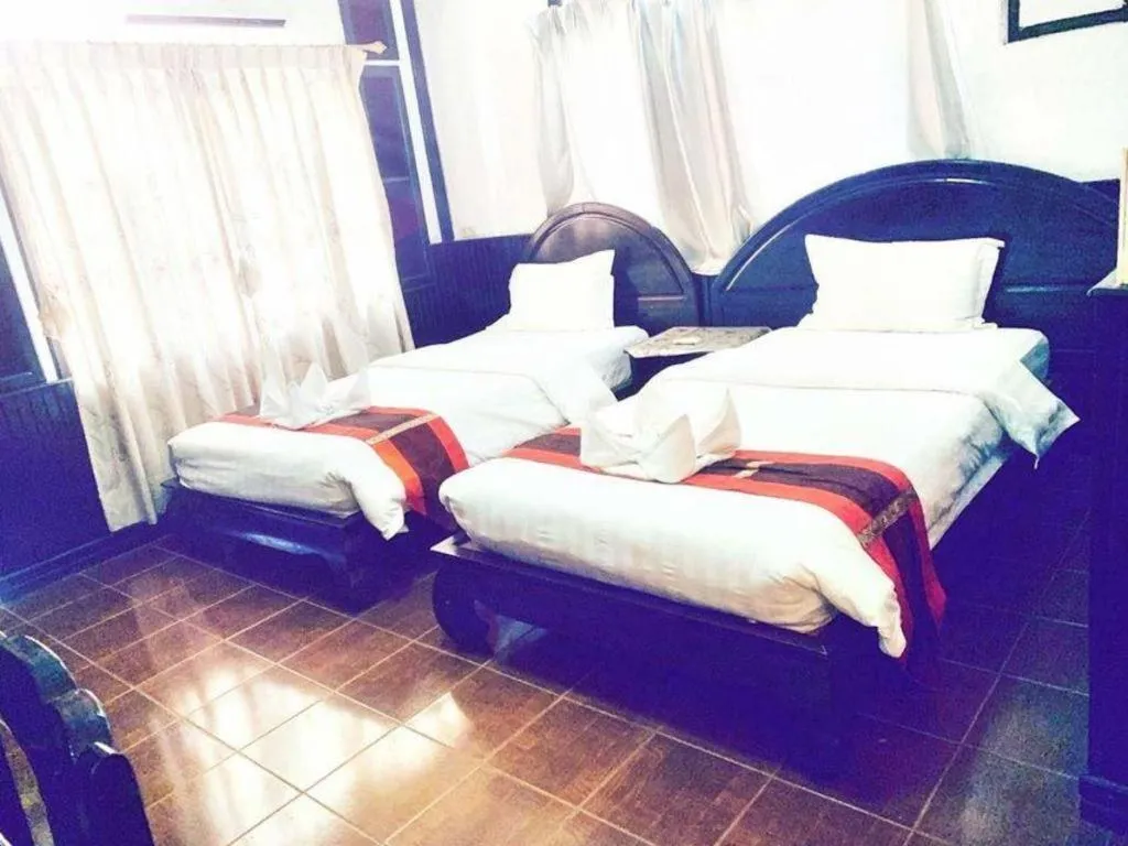 Bed in New Lao Paris Hotel