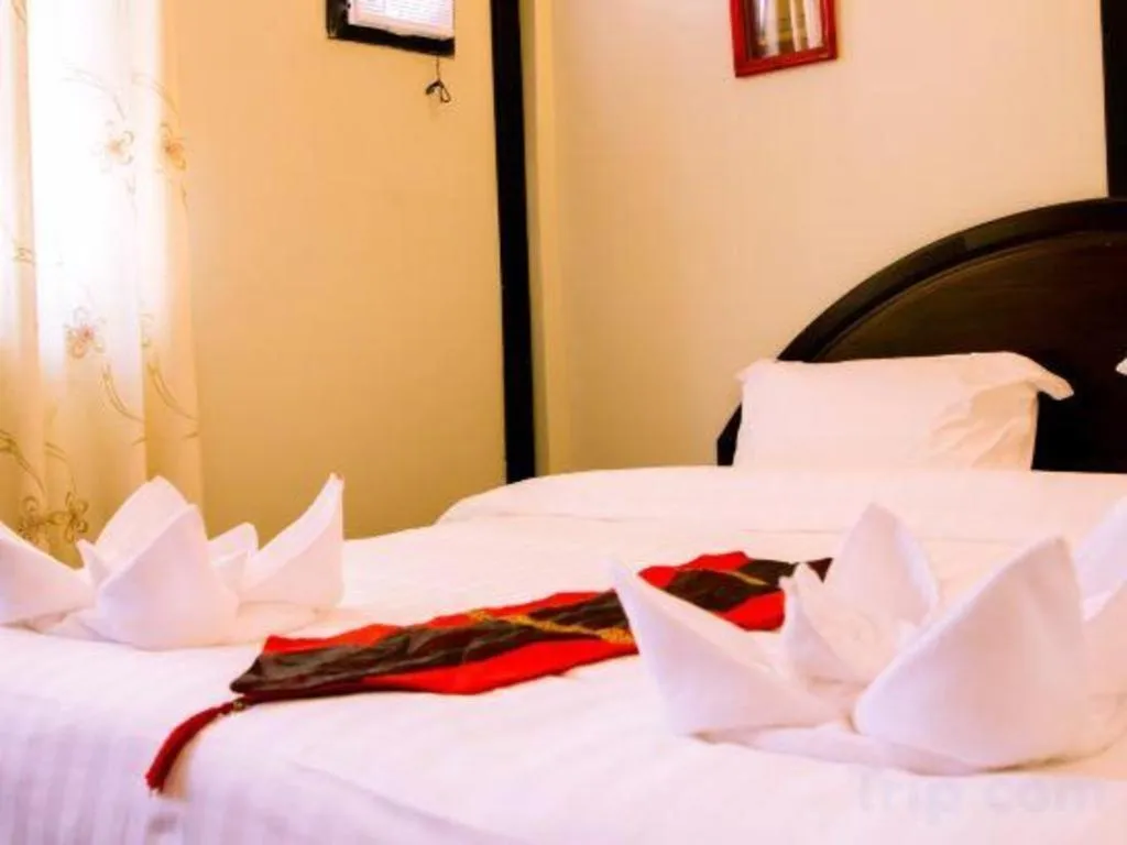 Bed in New Lao Paris Hotel