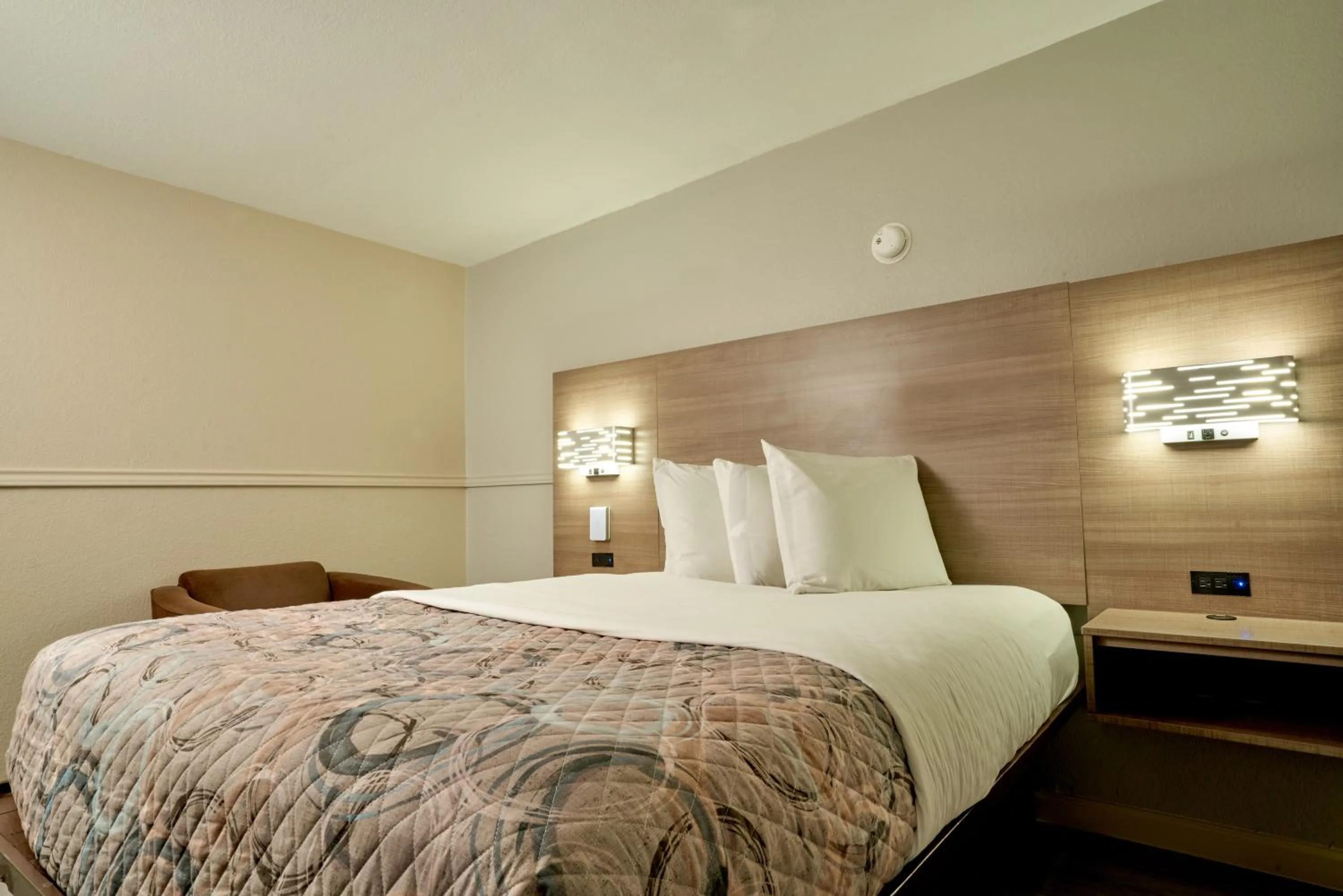 Bed in Family Garden Inn & Suites