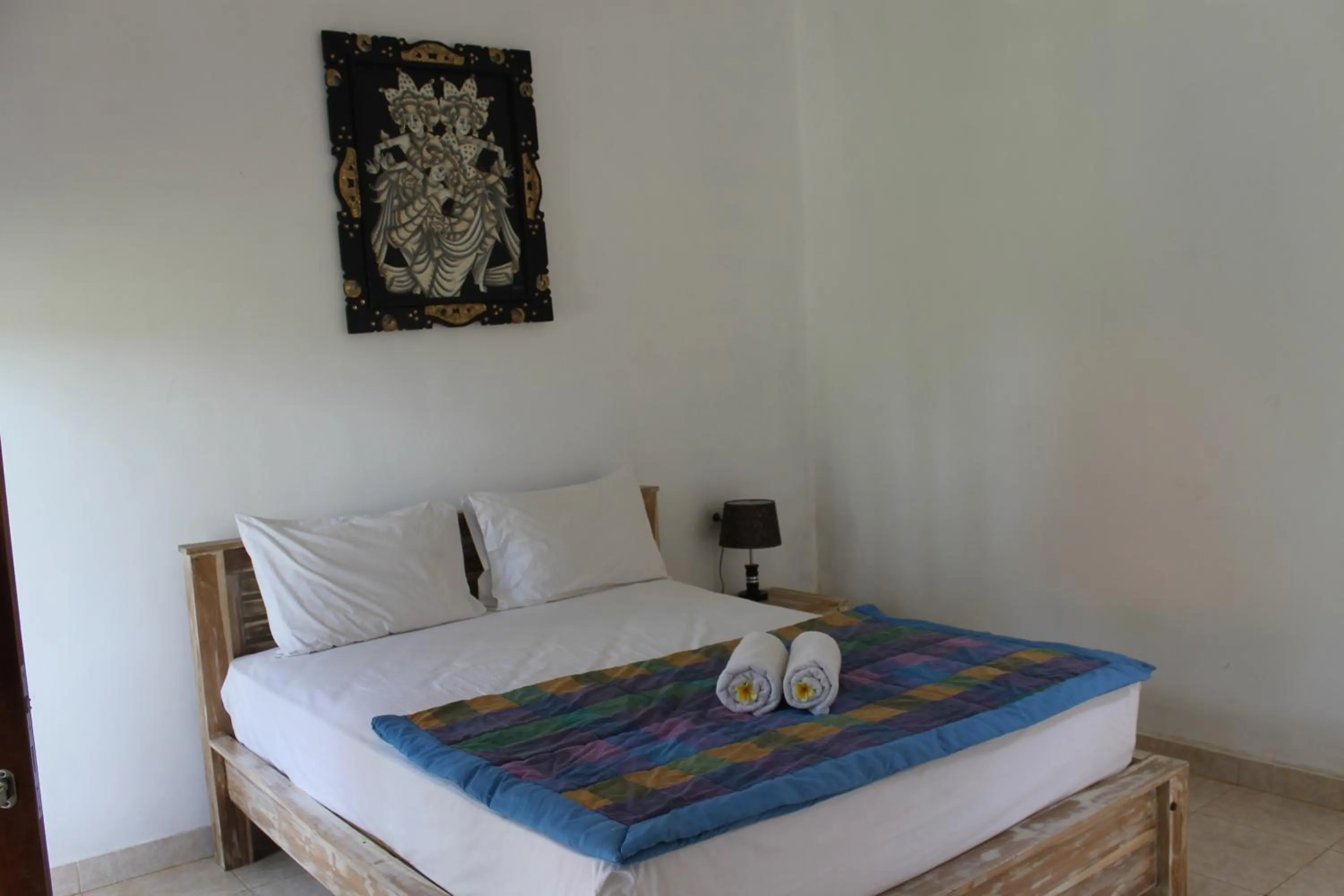 Bed in Nyoman Guesthouse and Grill