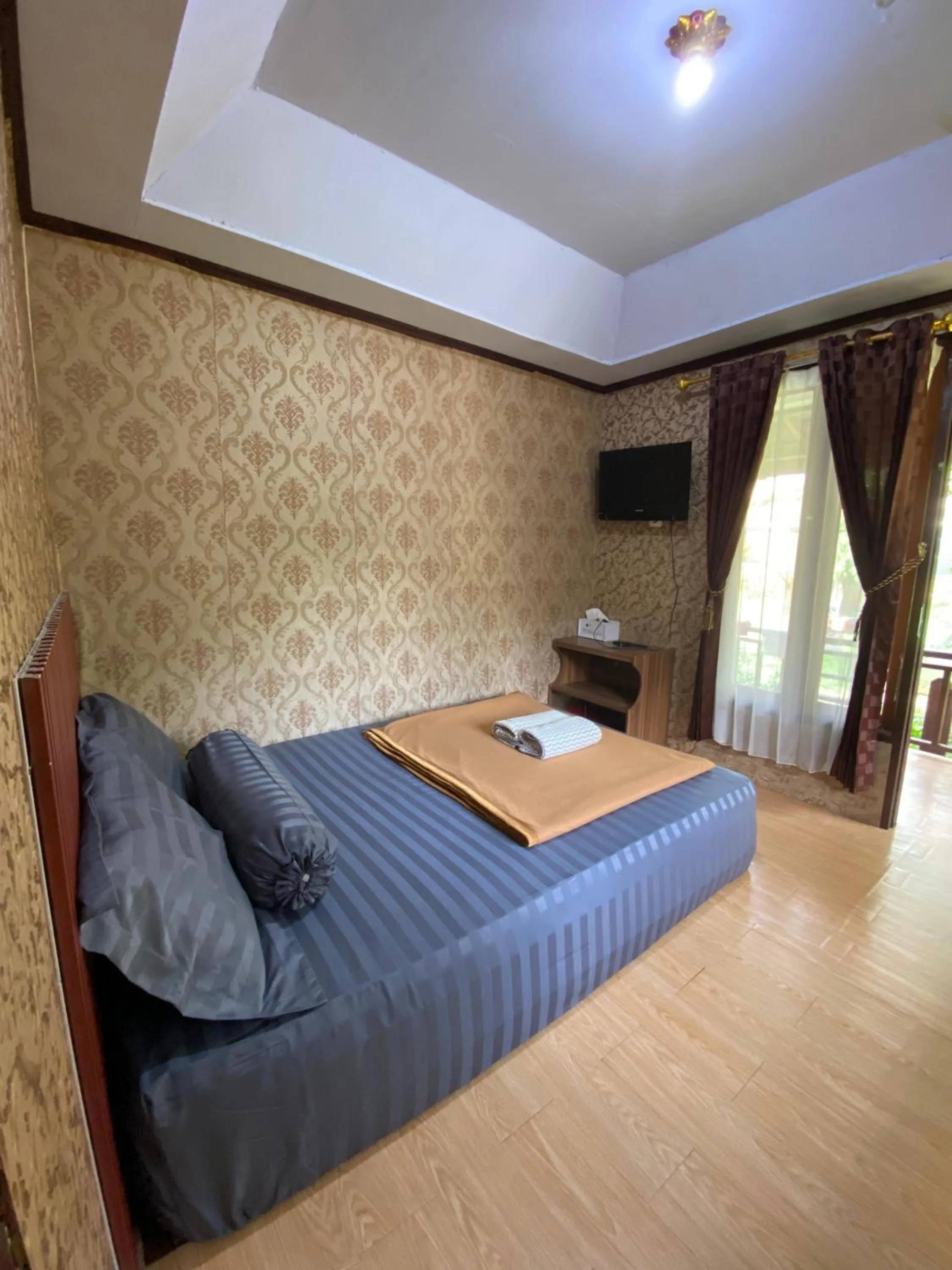 Bed in Puncak Rinjani Lodge
