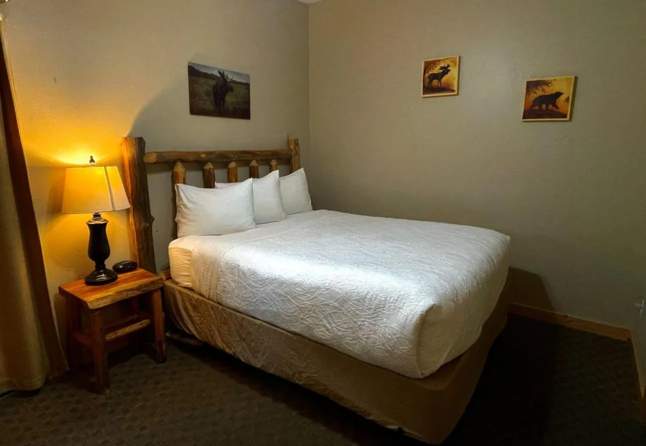 Bed in Riverfront Motel & Cabins