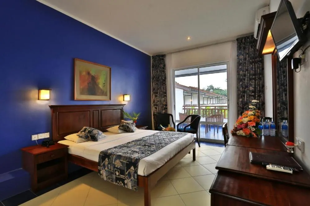 Bed in Hibiscus Beach Hotel & Villas