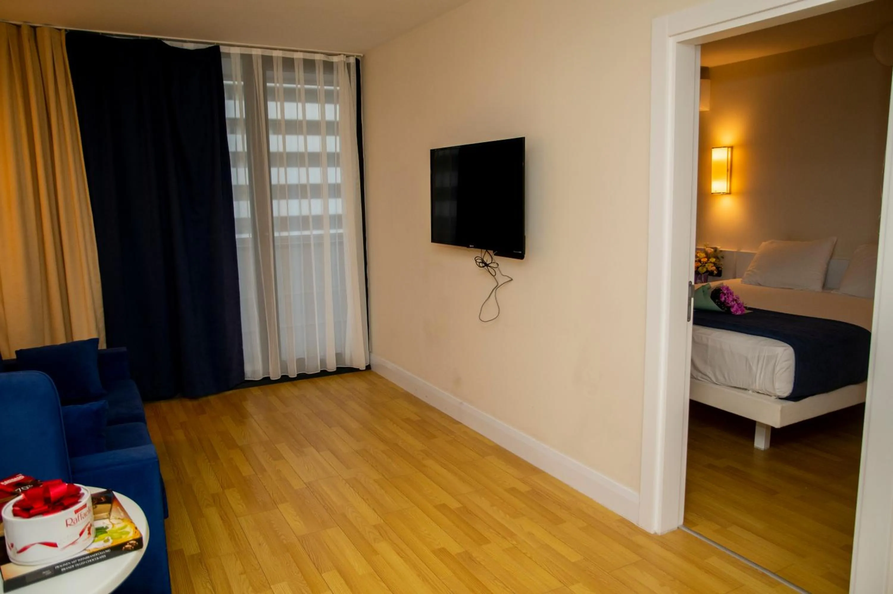 Communal lounge/ TV room, Bed in Orbi City Hotel