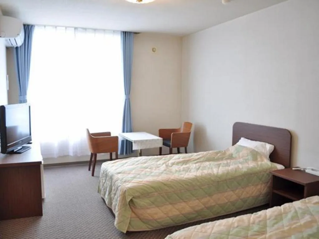 Bed in Ryobou Hanaemi Hotel