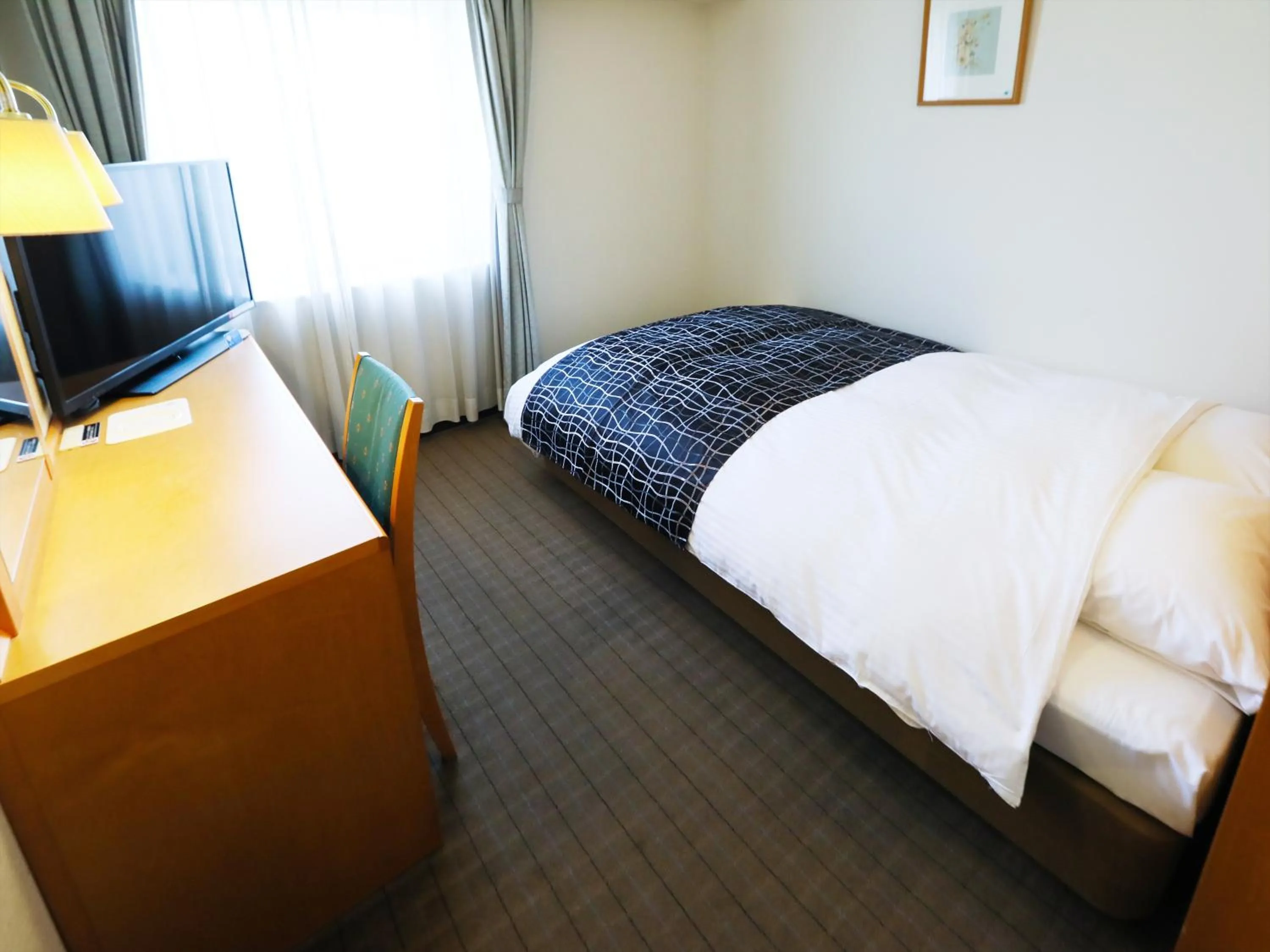 Photo of the whole room, Bed in APA Hotel Obihiro Ekimae
