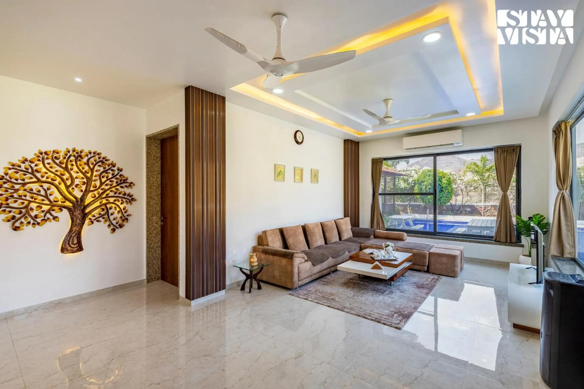 Living room in StayVista's Bella Dream - Mountain-View with Outdoor Pool, Lawn featuring a Gazebo & Indoor Games