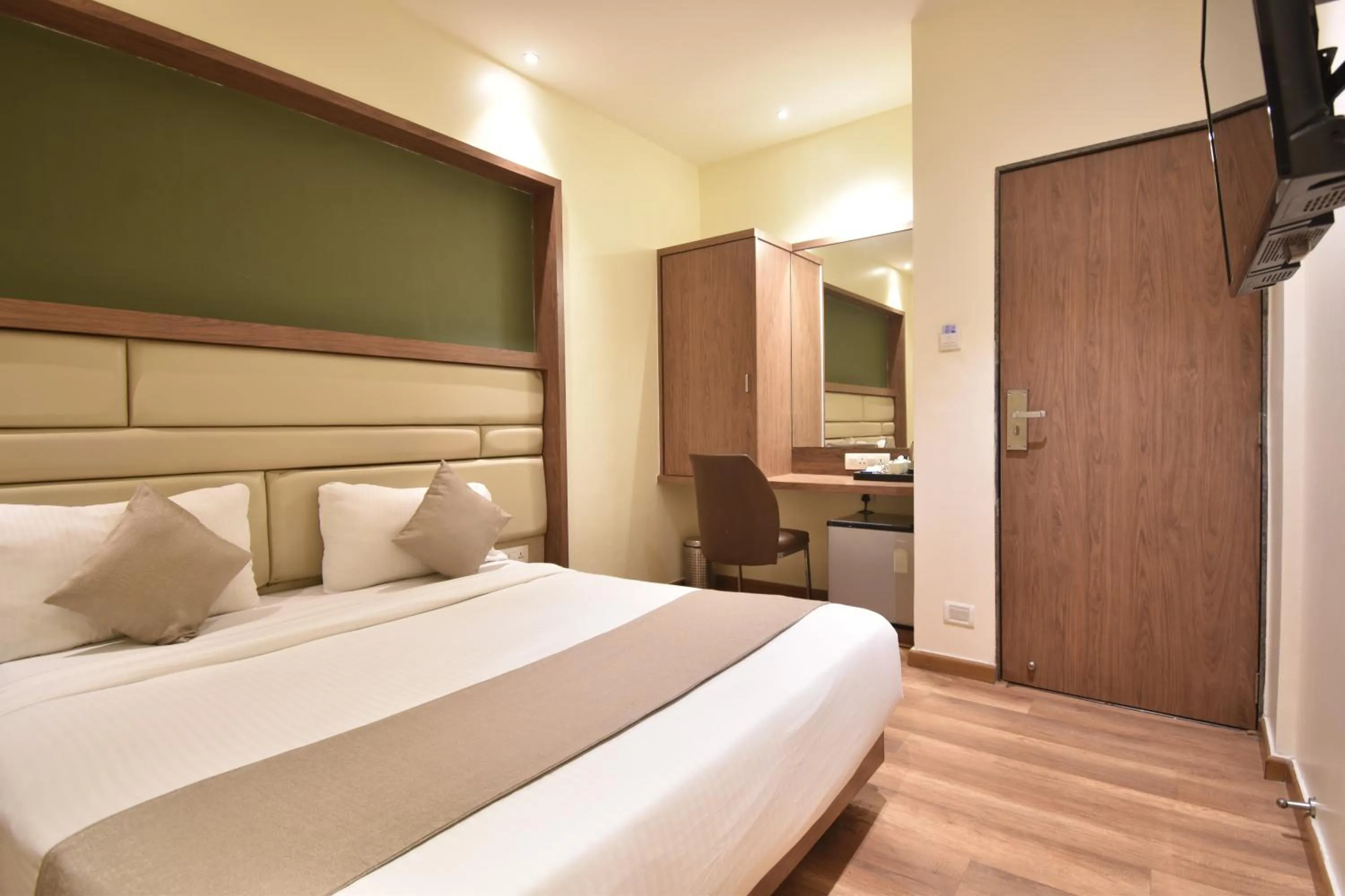 Bed in The Aarya A Smart Business Hotel