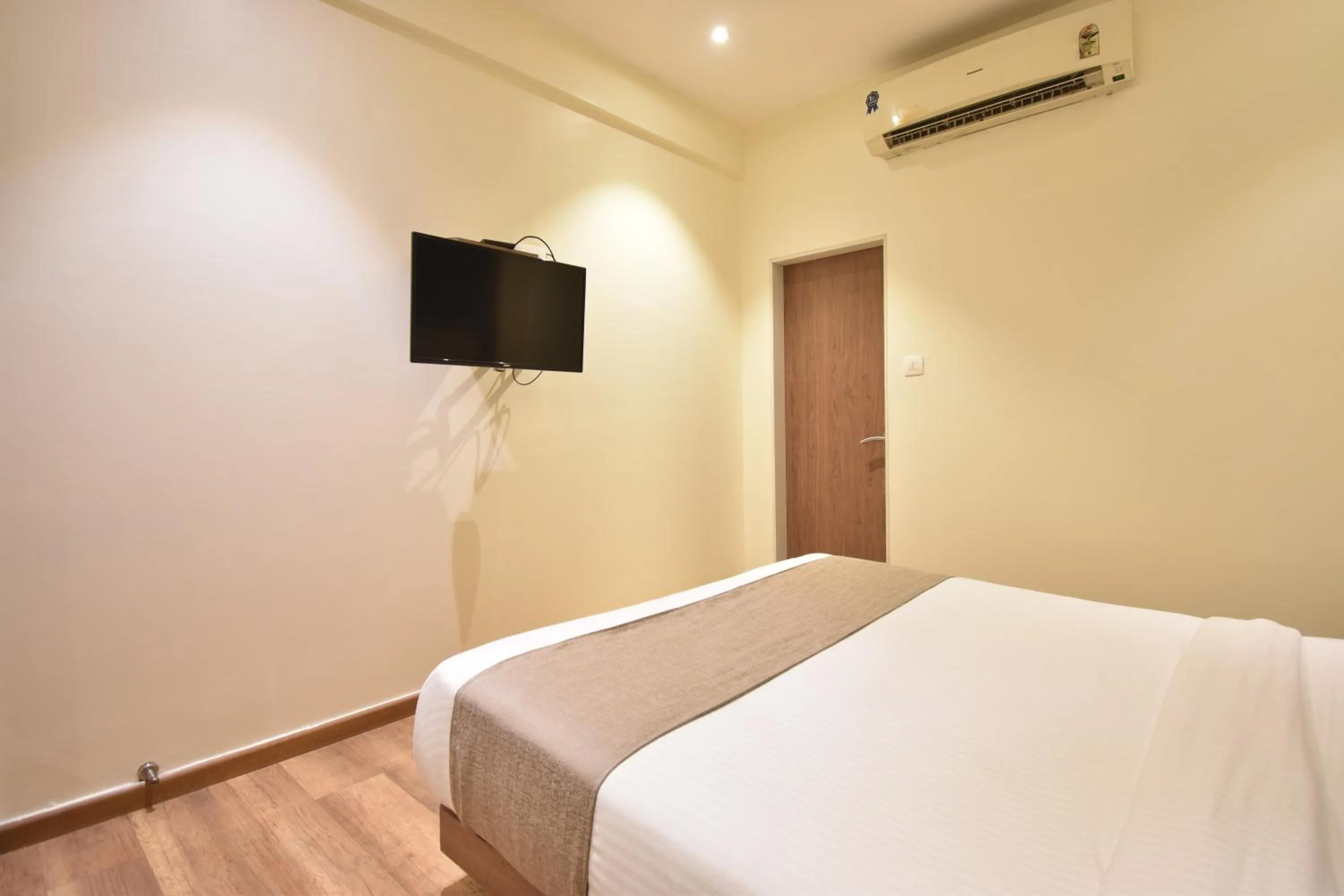 Bed in The Aarya A Smart Business Hotel