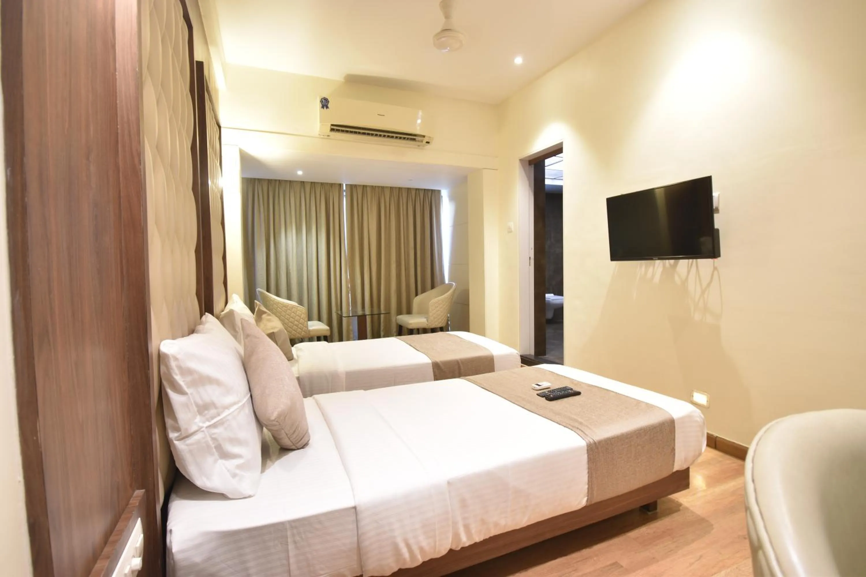 Communal lounge/ TV room, Bed in The Aarya A Smart Business Hotel