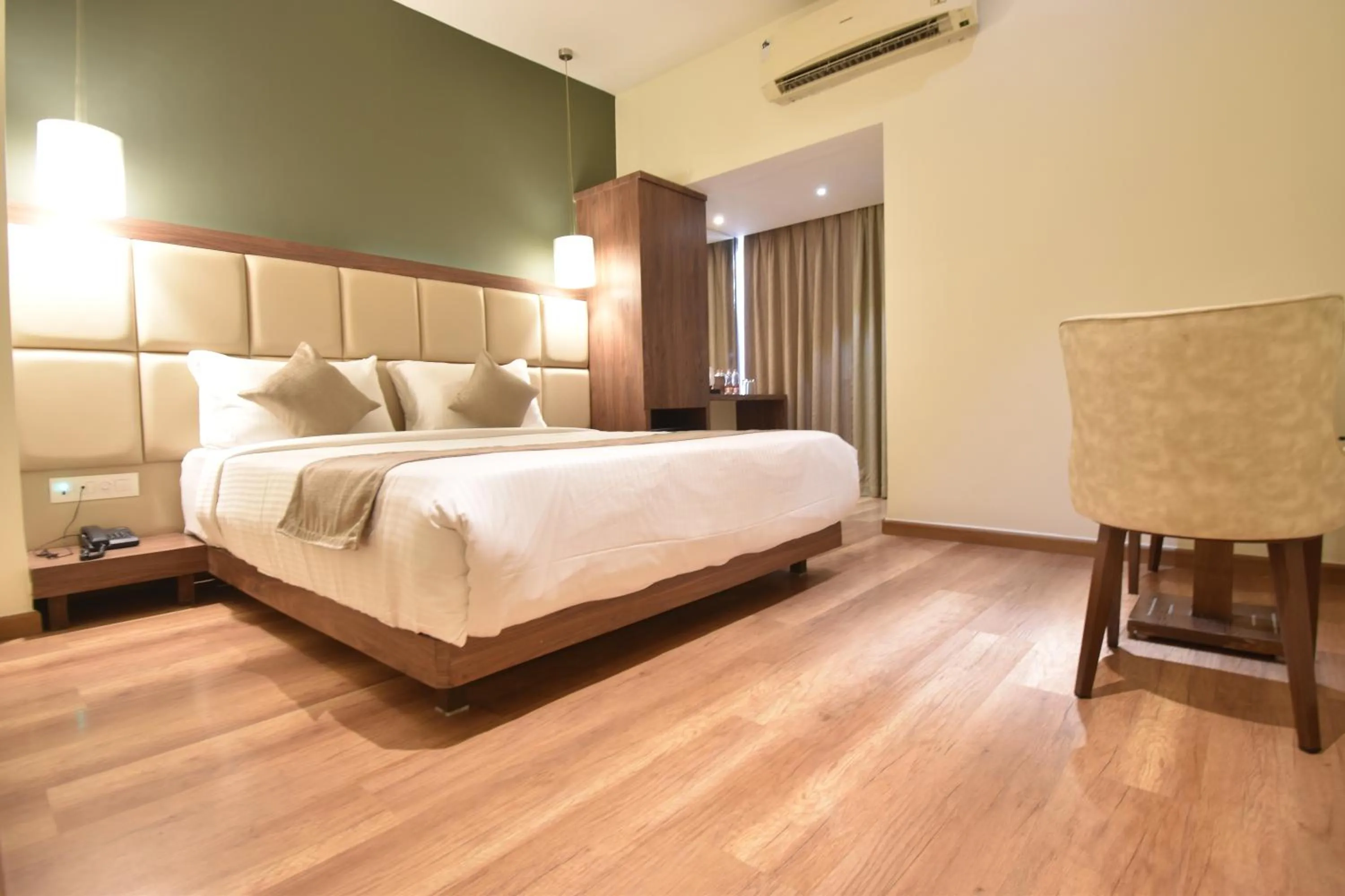 Seating area, Bed in The Aarya A Smart Business Hotel