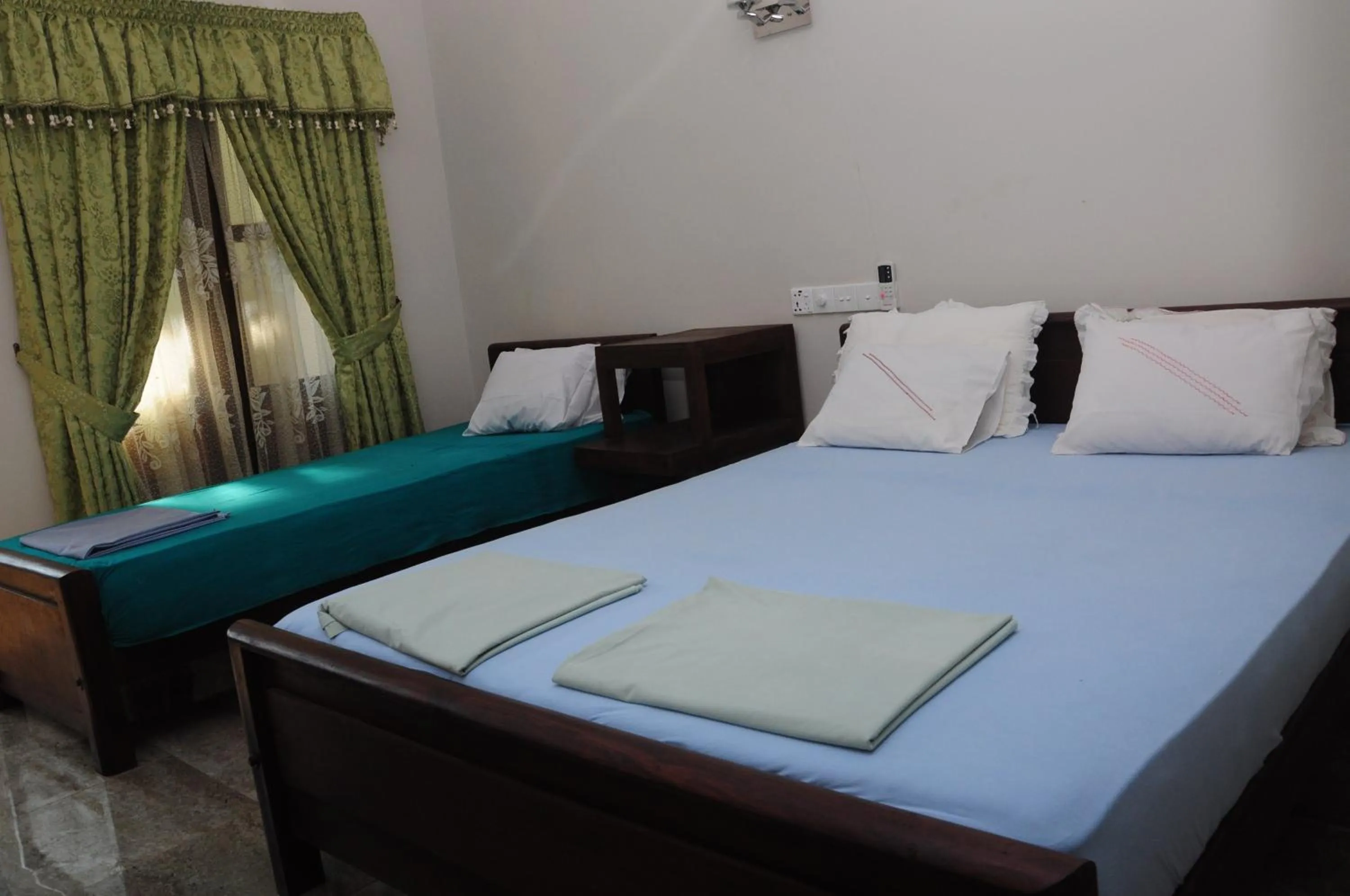 Bed in Traveller's Home Hotel