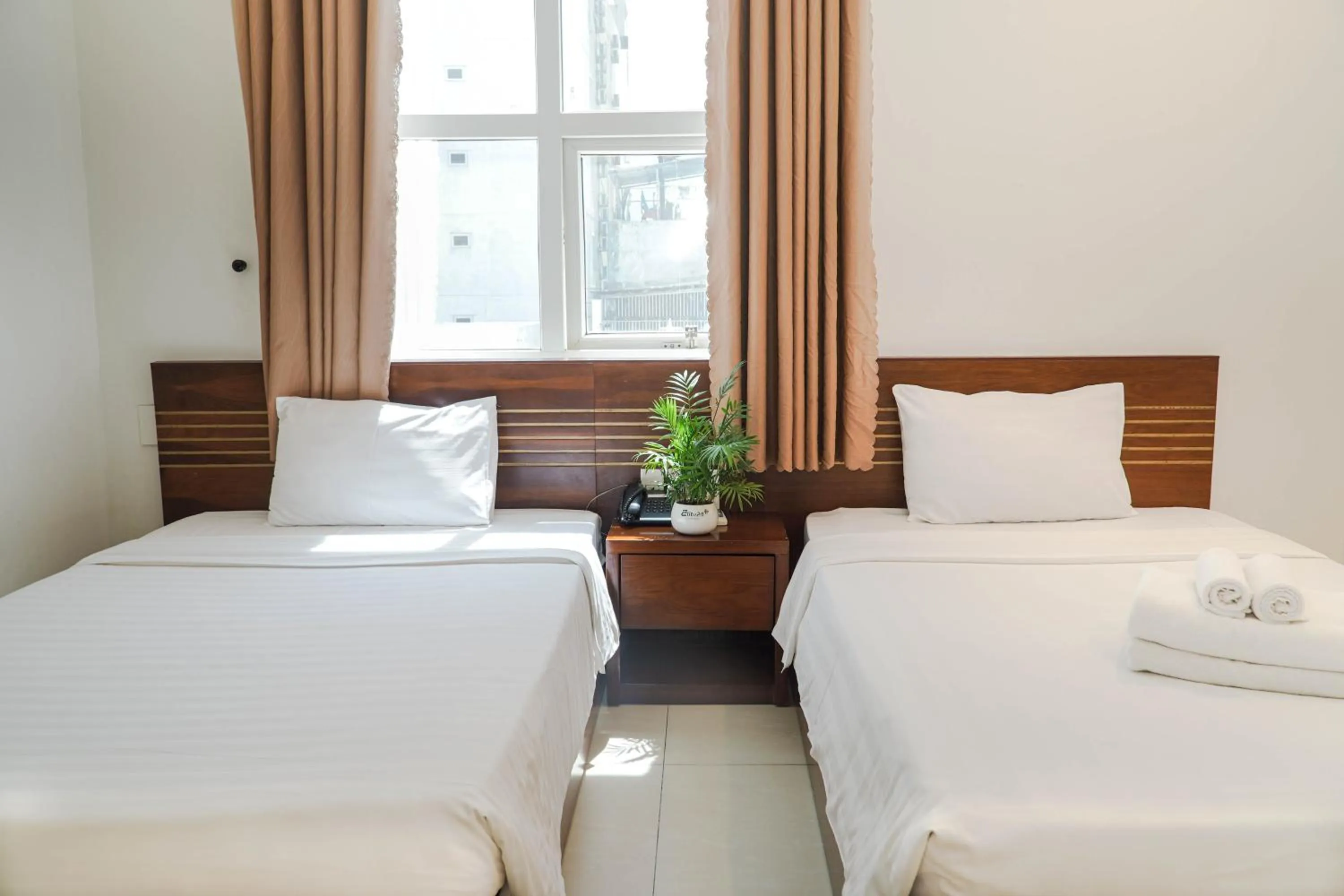 Bed in Golden Light Da Nang Hotel