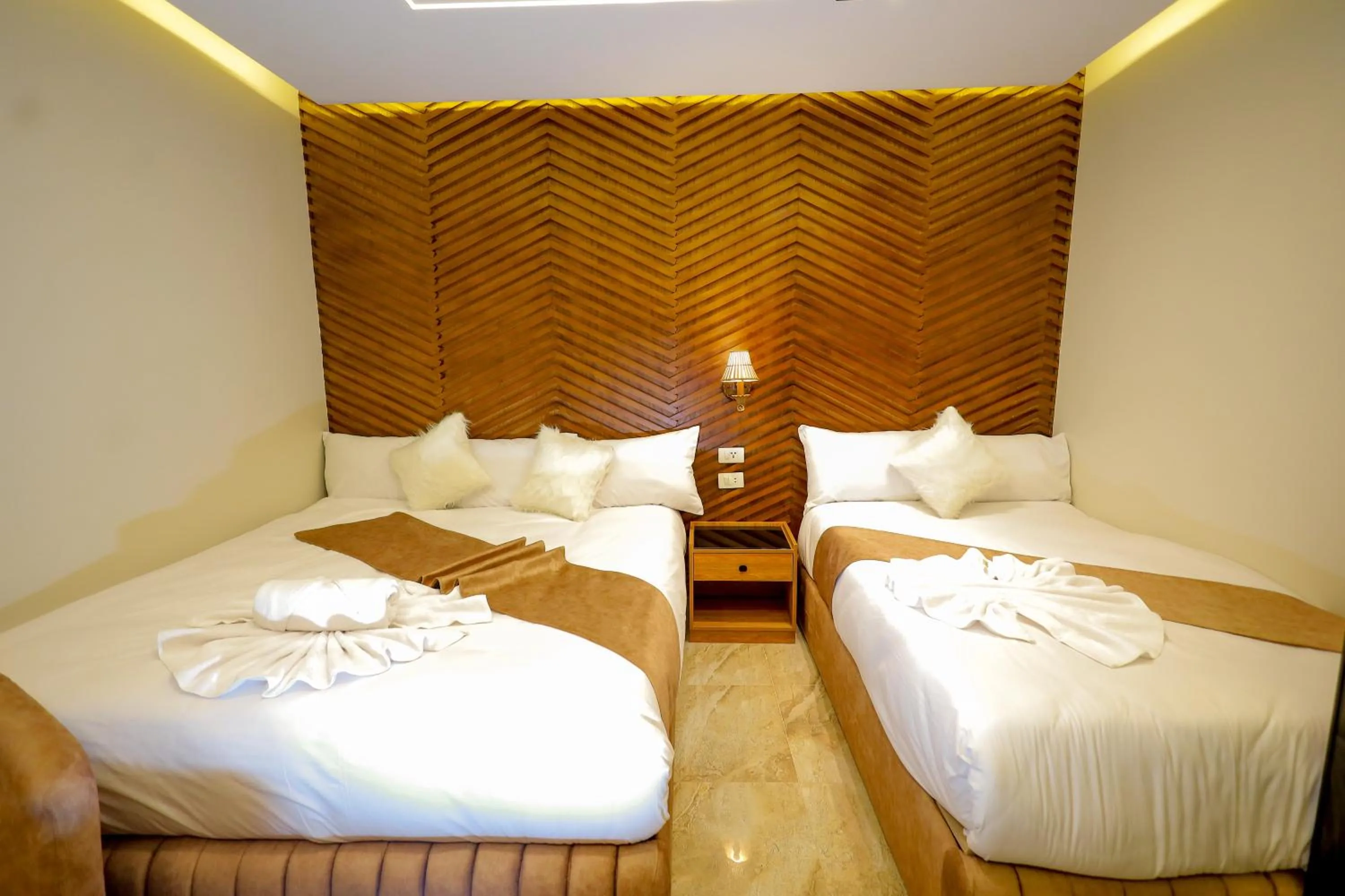 Bed in The Muse Pyramids INN