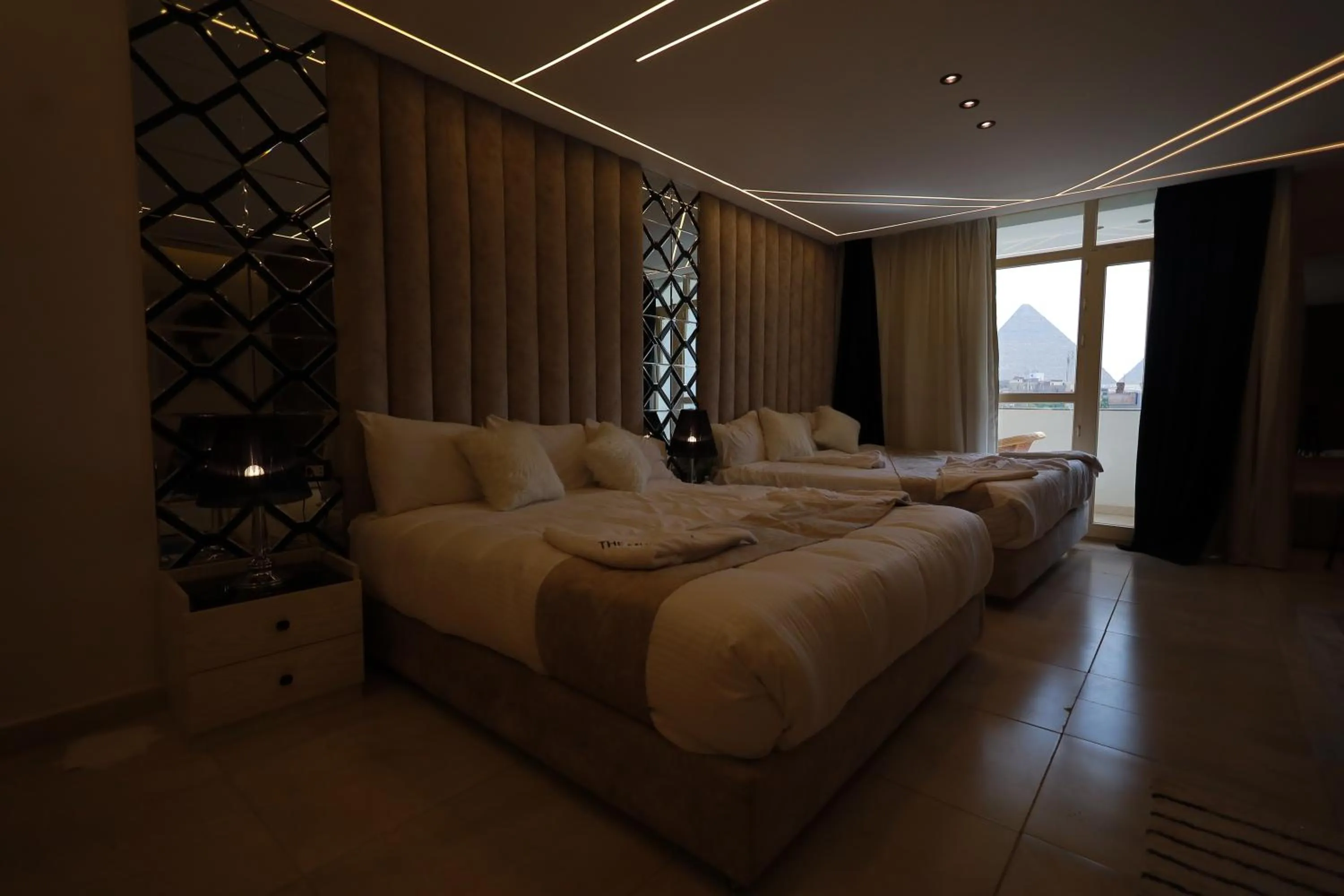 Bed in The Muse Pyramids INN