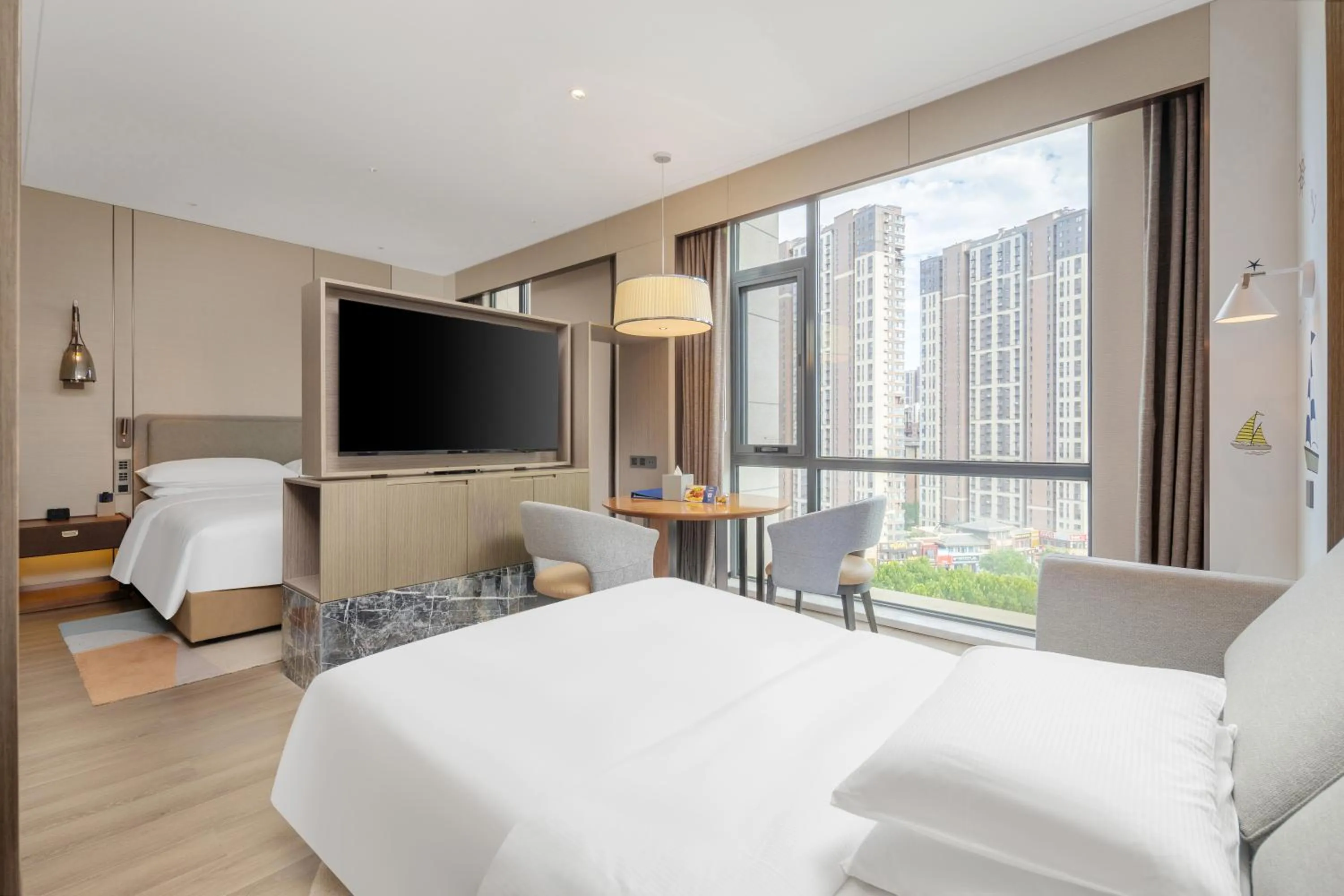 Photo of the whole room, Bed in Doubletree By Hilton Yantai Golden Coast Hotel & Suites