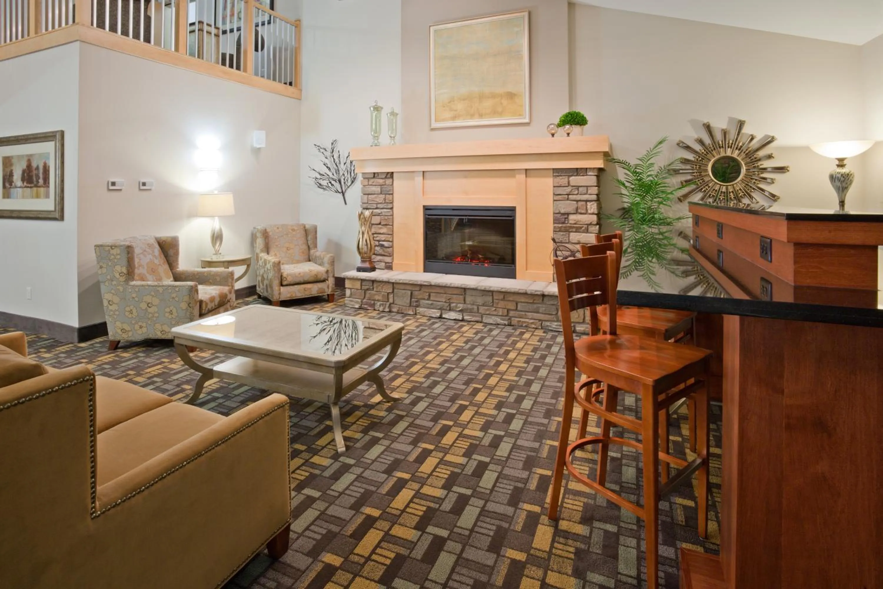 Communal lounge/ TV room in AmericInn by Wyndham Hawley