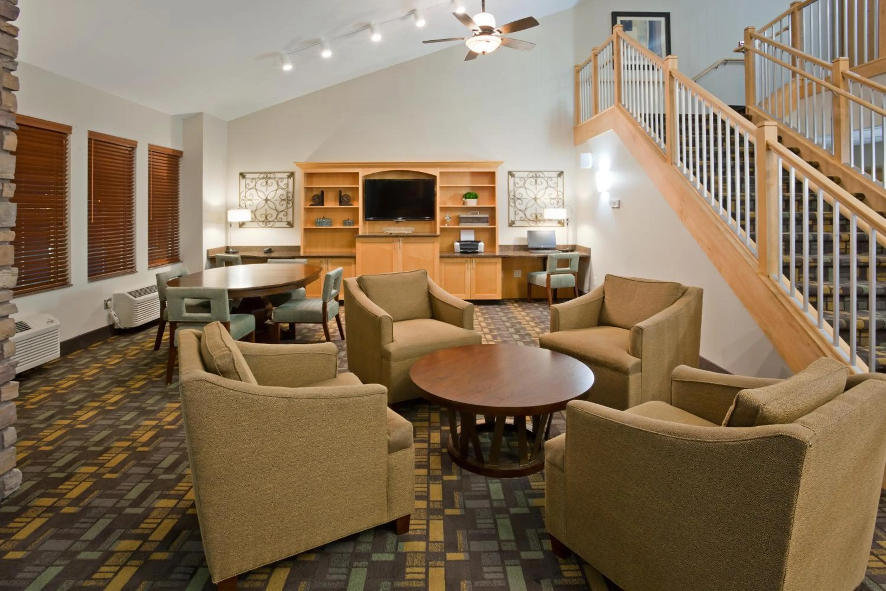 Communal lounge/ TV room in AmericInn by Wyndham Hawley