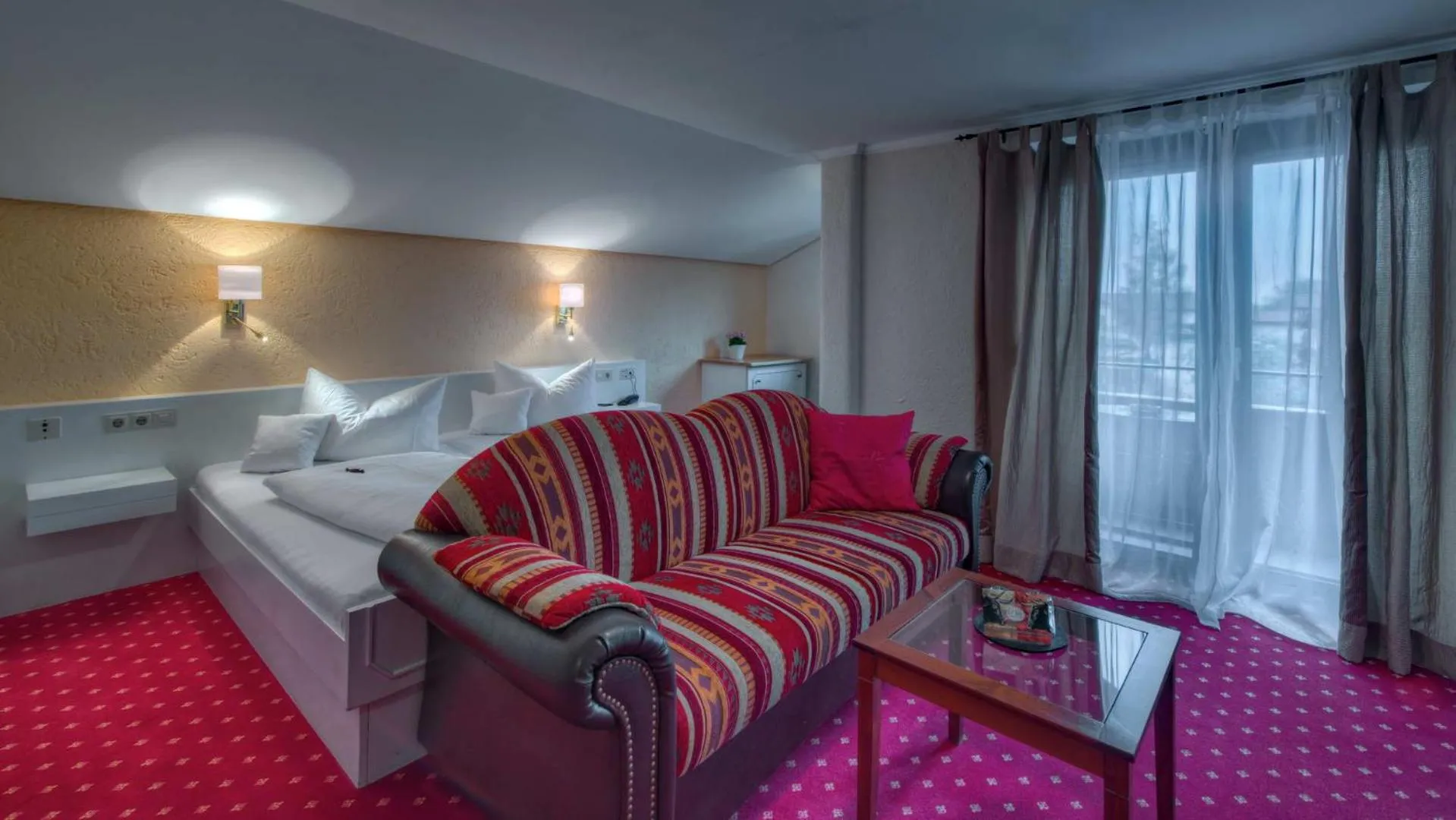 Bed, Seating Area in H+ Hotel Oberstaufen