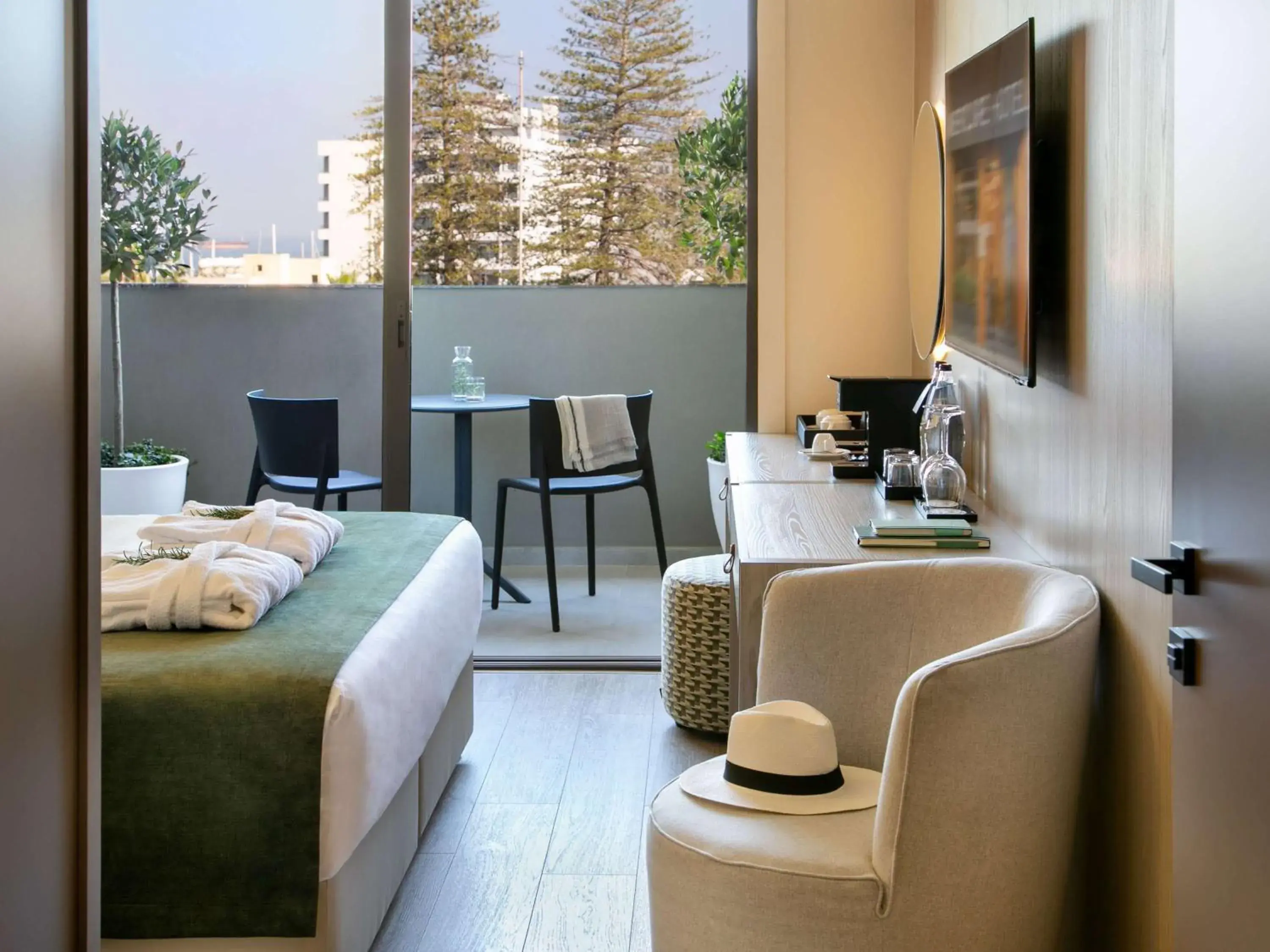 Superior room with double bed, sofa and balcony in Mercure Larnaca Finikoudes Beach Superior room with double bed, sofa and balcony in Mercure Larnaca Finikoudes Beach