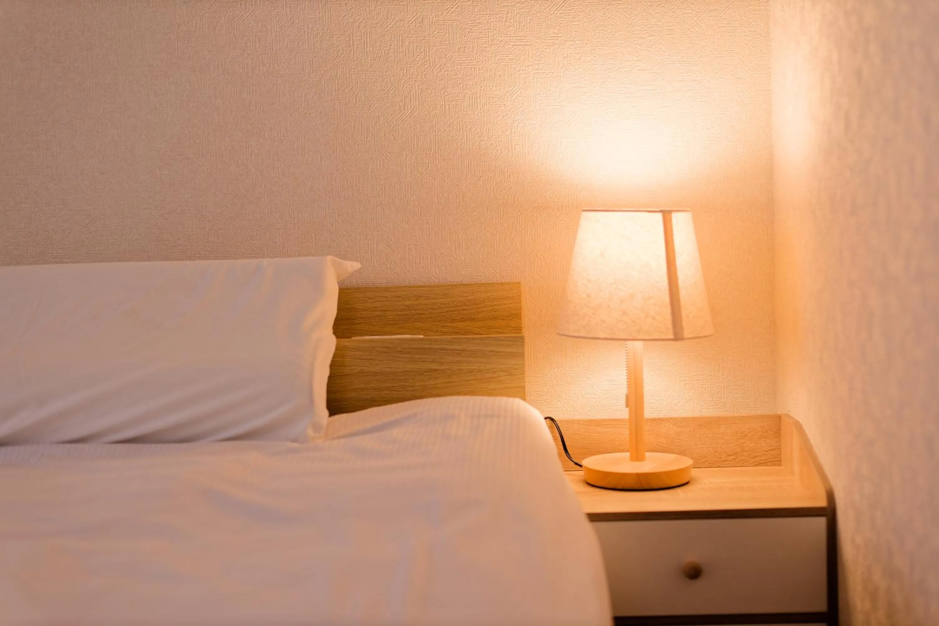 Bed in Shinjuku Waseda Earthtone Apartment