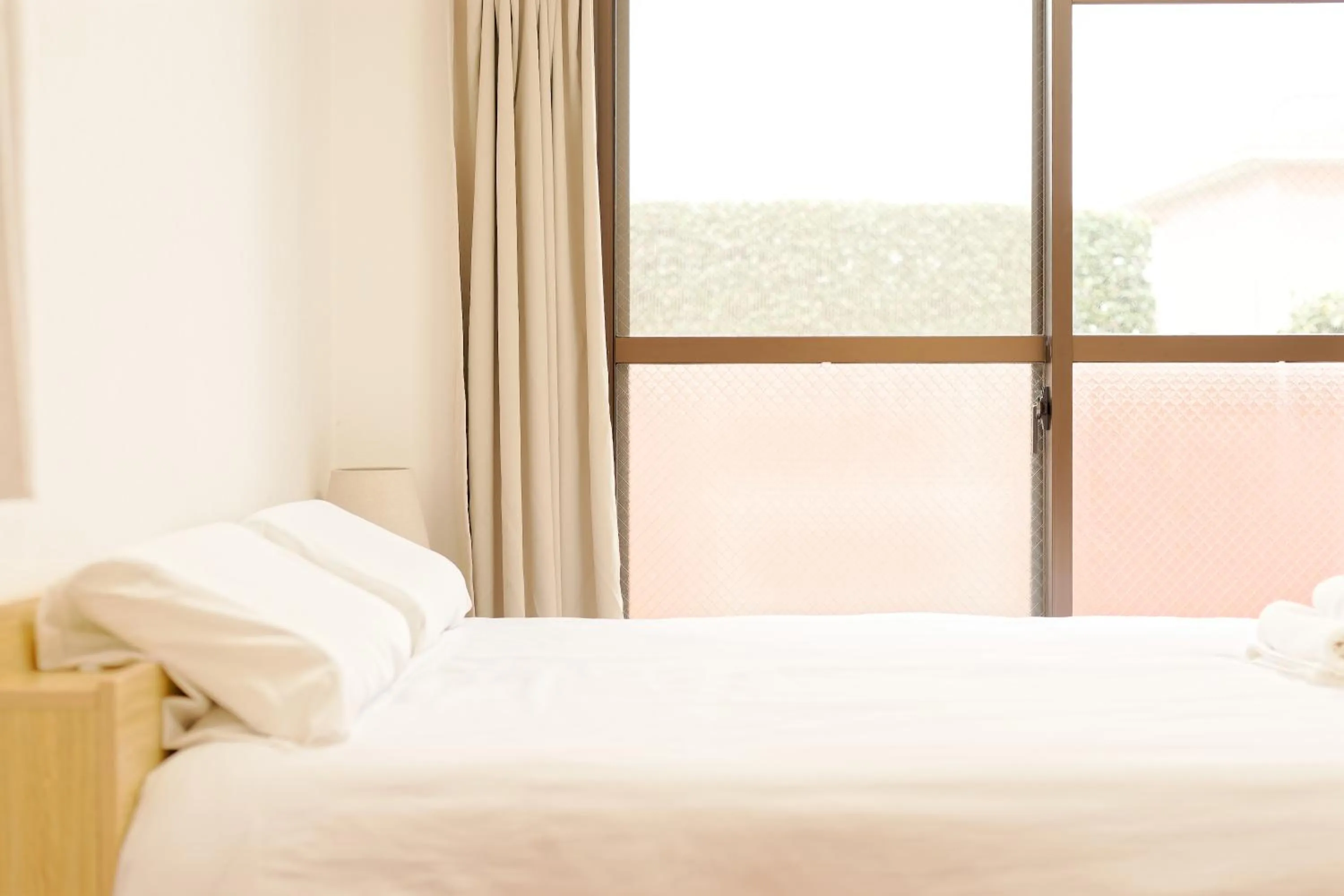 Bed in Shinjuku Waseda Earthtone Apartment