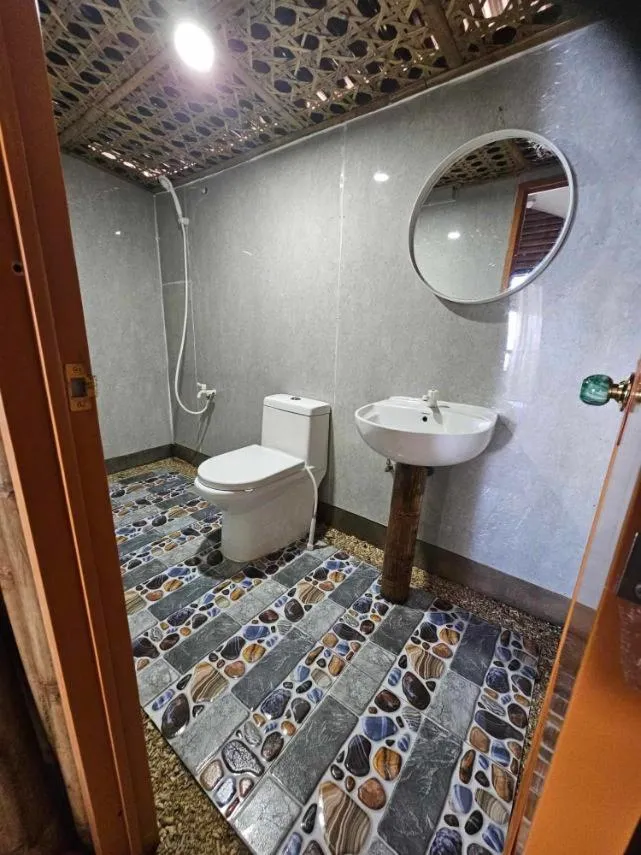 Bathroom in Tambayan Rooms and Cottages by SMS Hospitality