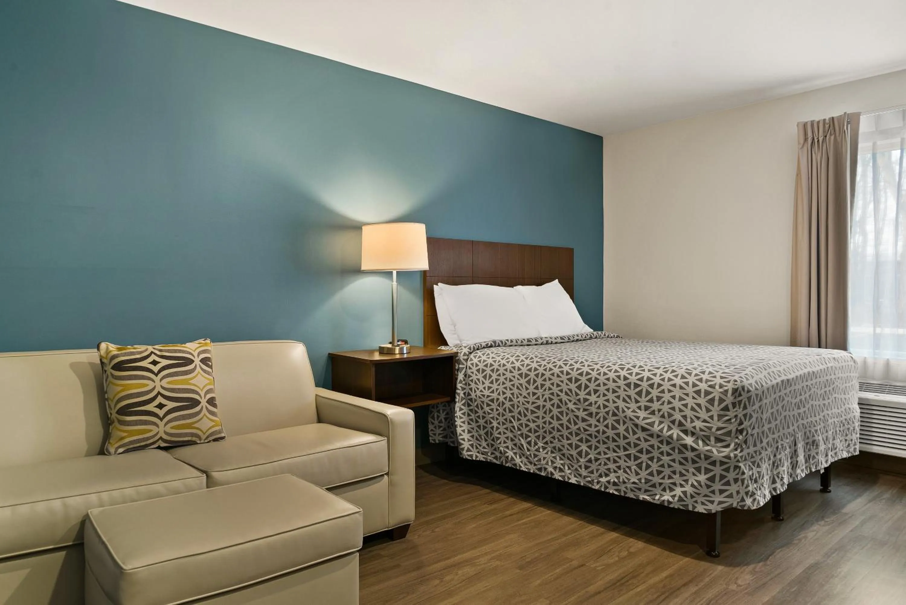 Seating area, Bed in WoodSpring Suites Winston-Salem near Hanes Mall