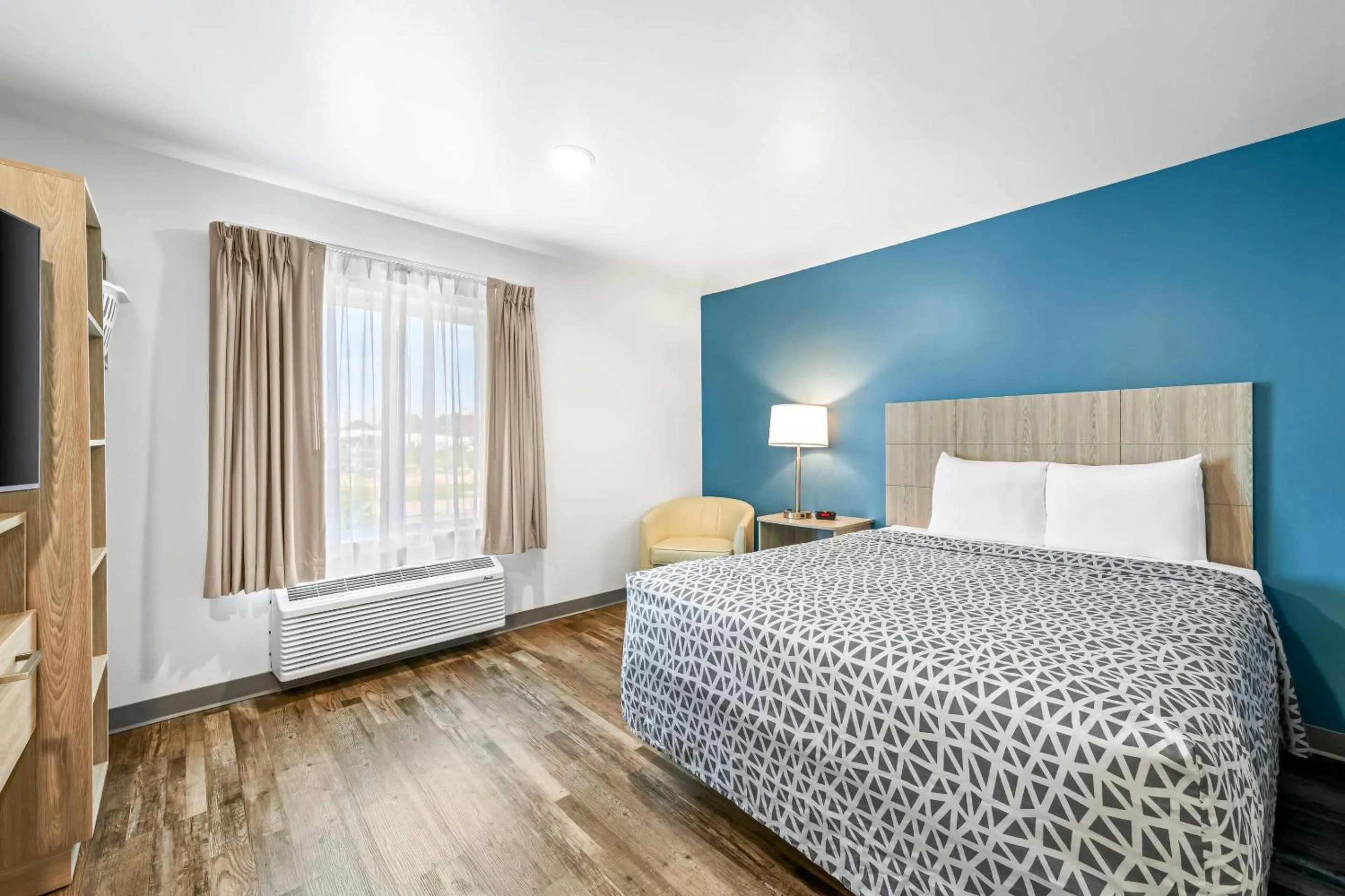 Bedroom, Bed in WoodSpring Suites Winston-Salem near Hanes Mall