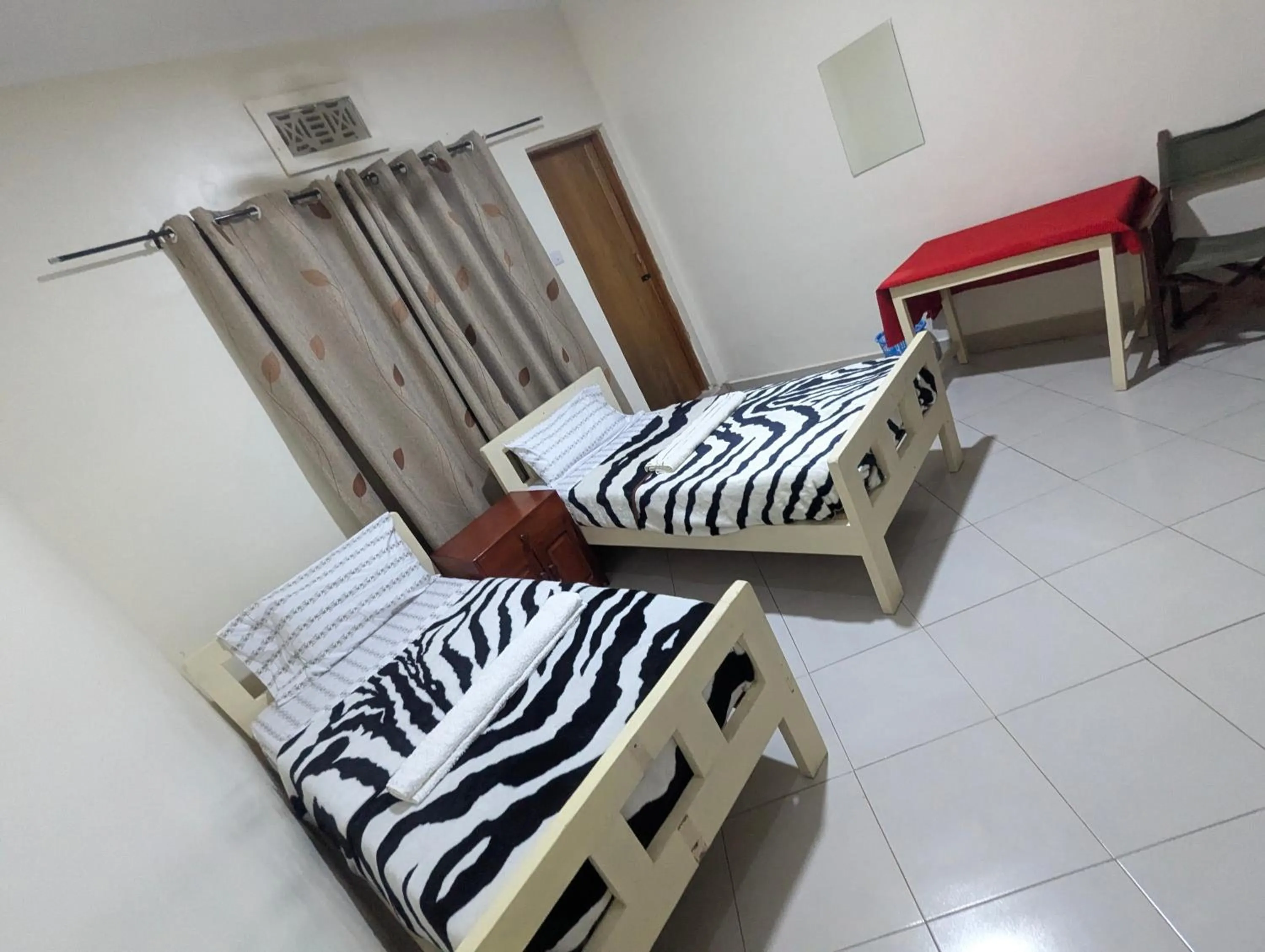 Bed in JACARANDA HOMESTAY