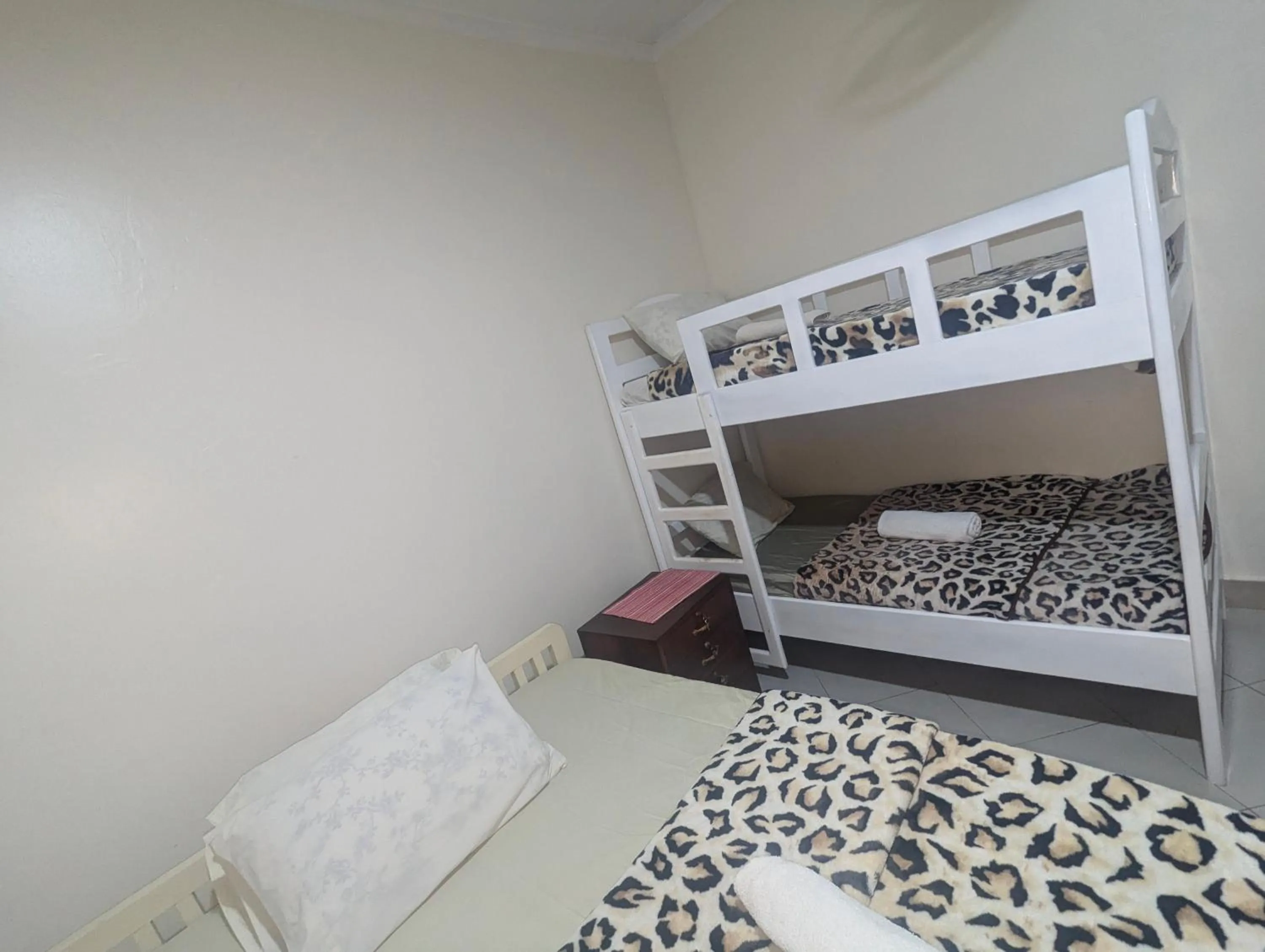 Bed in JACARANDA HOMESTAY