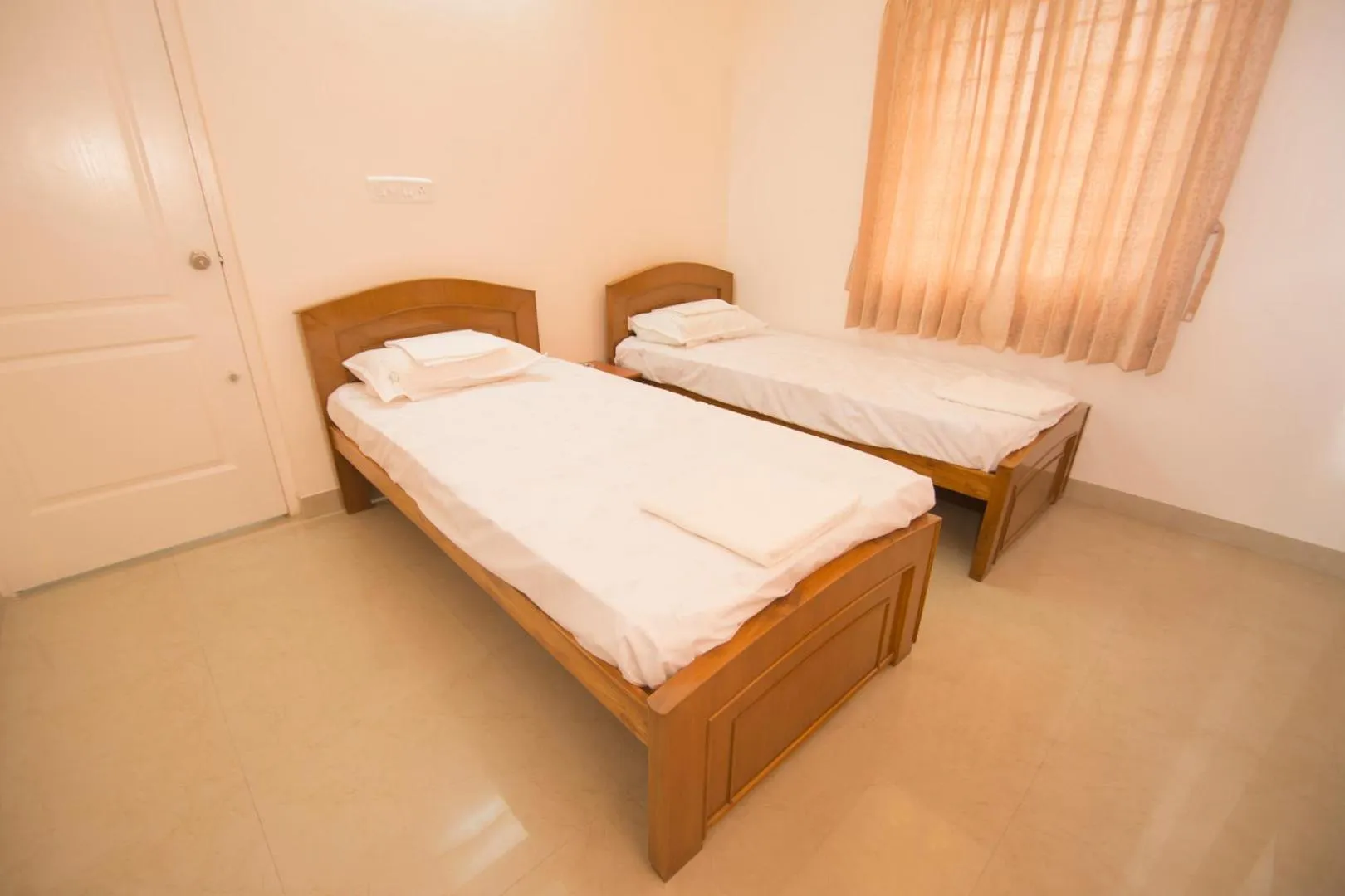 Bed in ThulasiRams Service Apartments