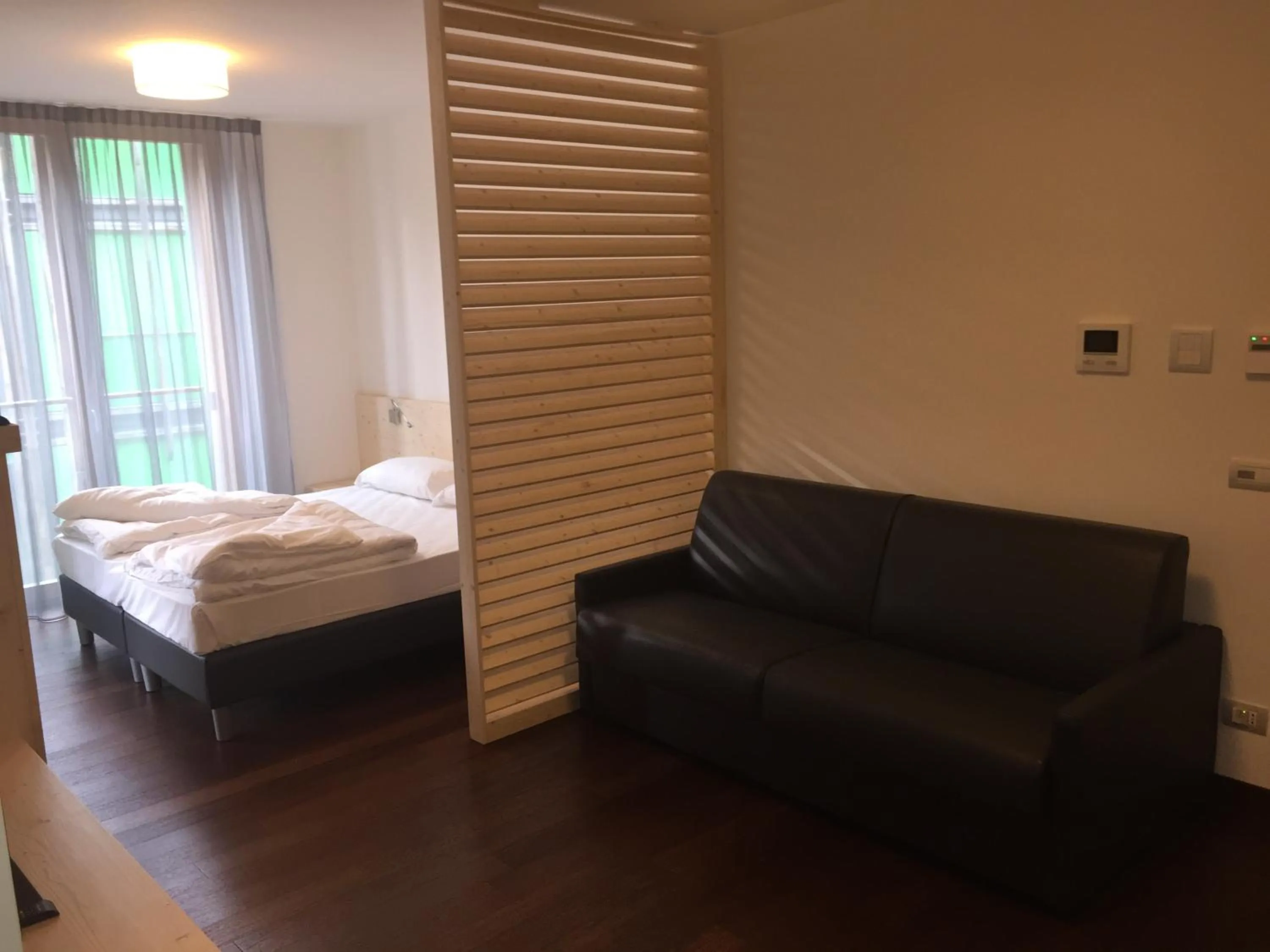 Living room, Bed in Komodo short stay apartments