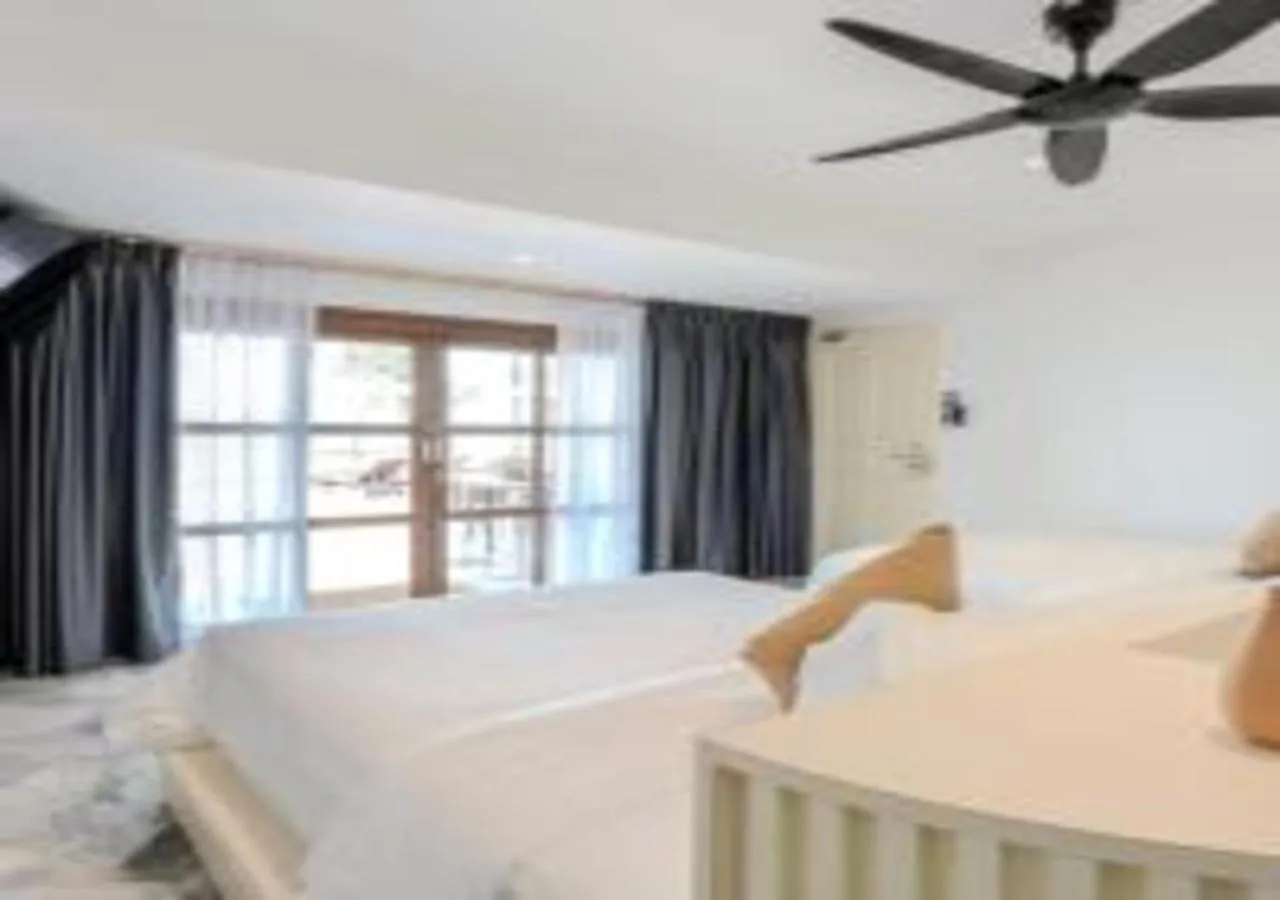 Bed in Suntai Villa, Beachfront Suites