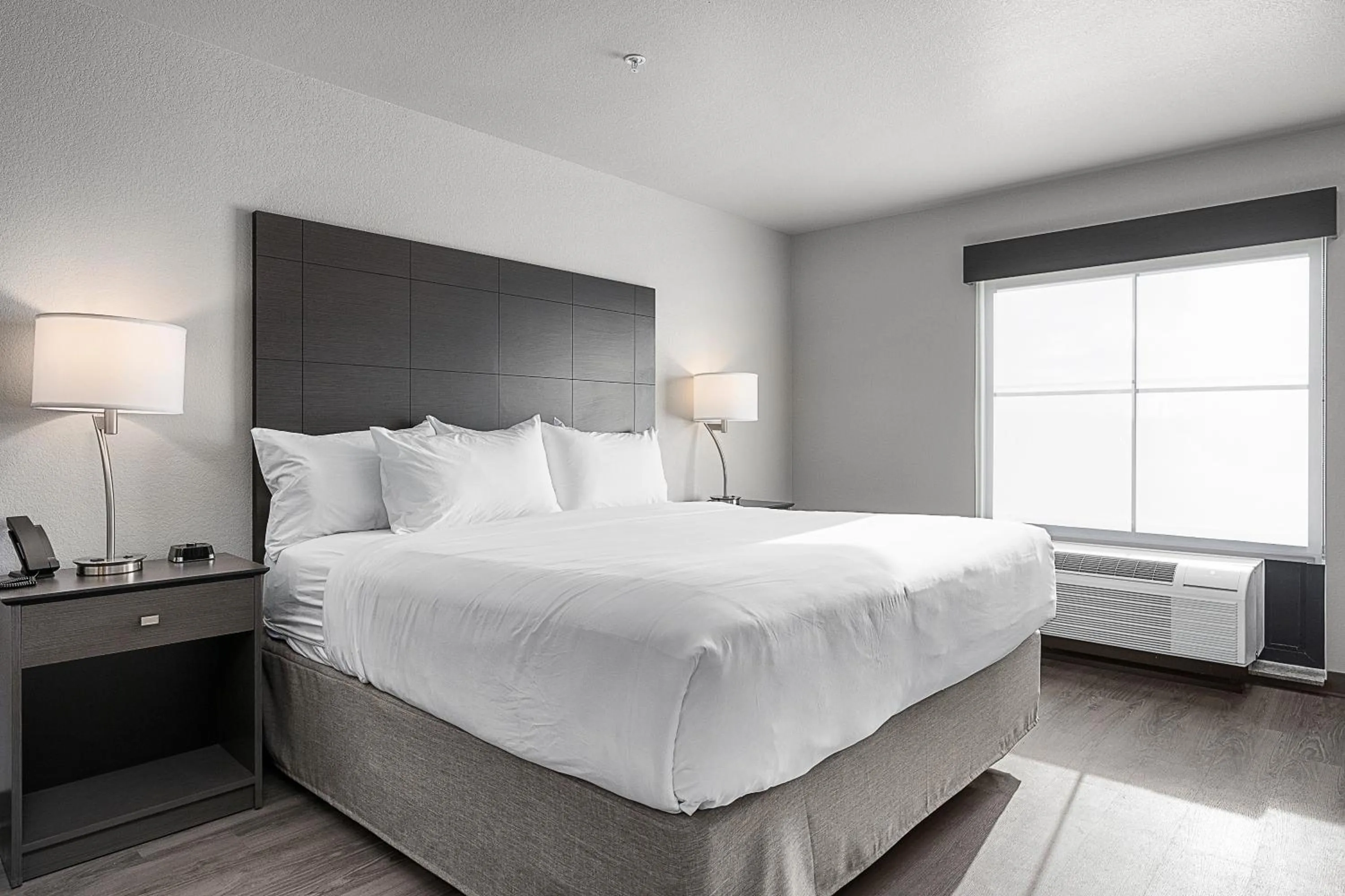Bedroom, Bed in Riverstone Suites by Cobblestone Hotels - Chippewa Falls