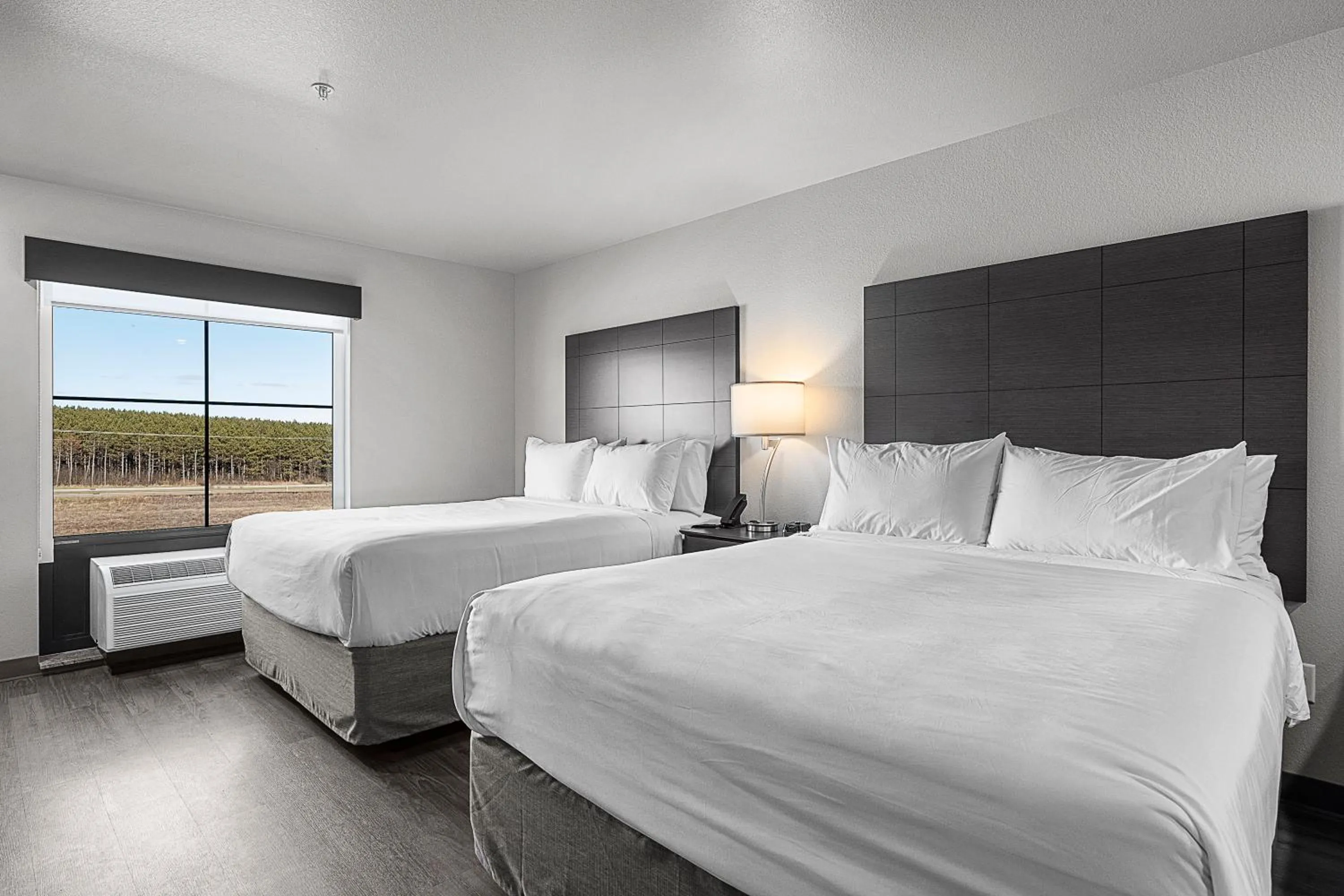 Bedroom, Bed in Riverstone Suites by Cobblestone Hotels - Chippewa Falls