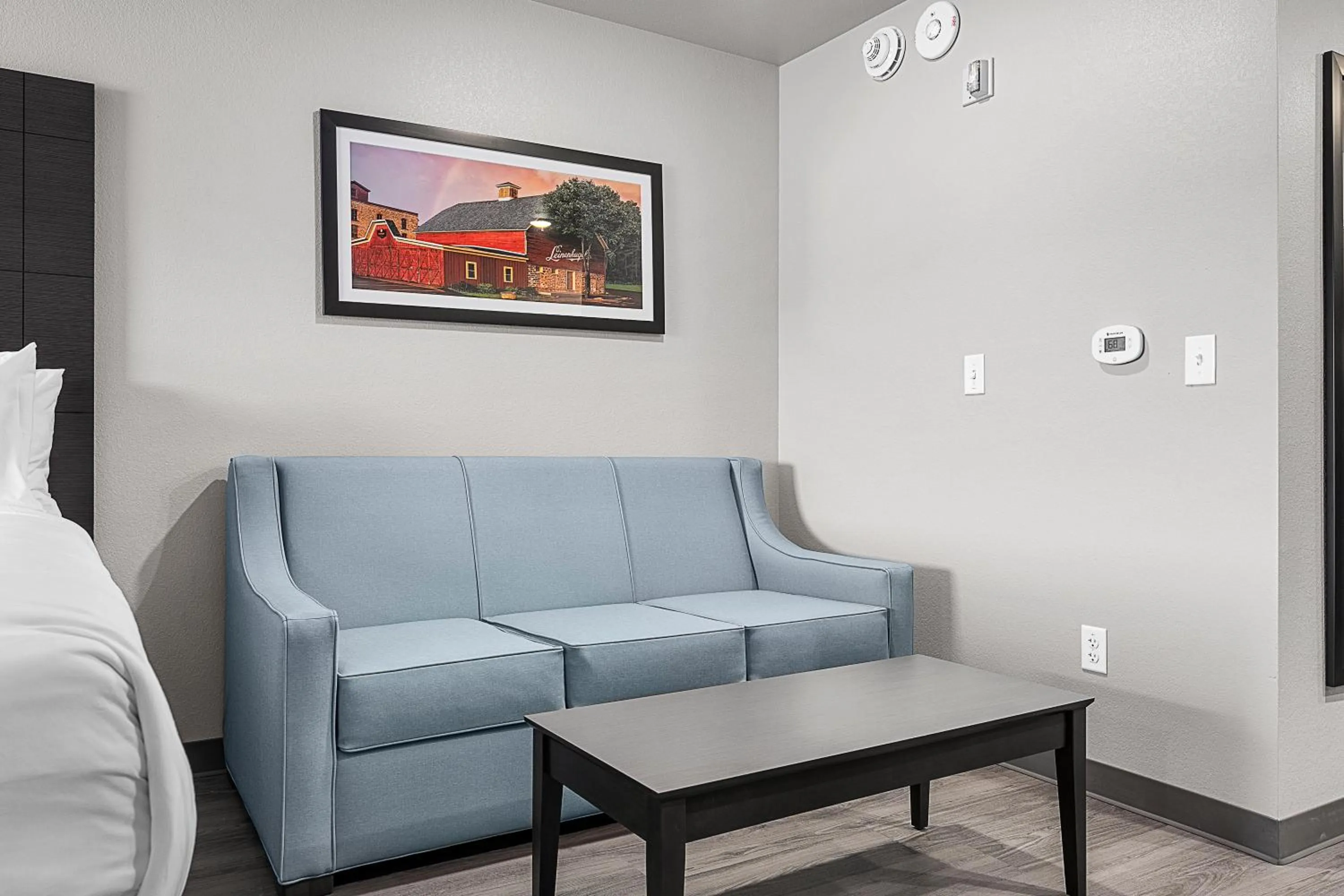 Seating area, Bed in Riverstone Suites by Cobblestone Hotels - Chippewa Falls
