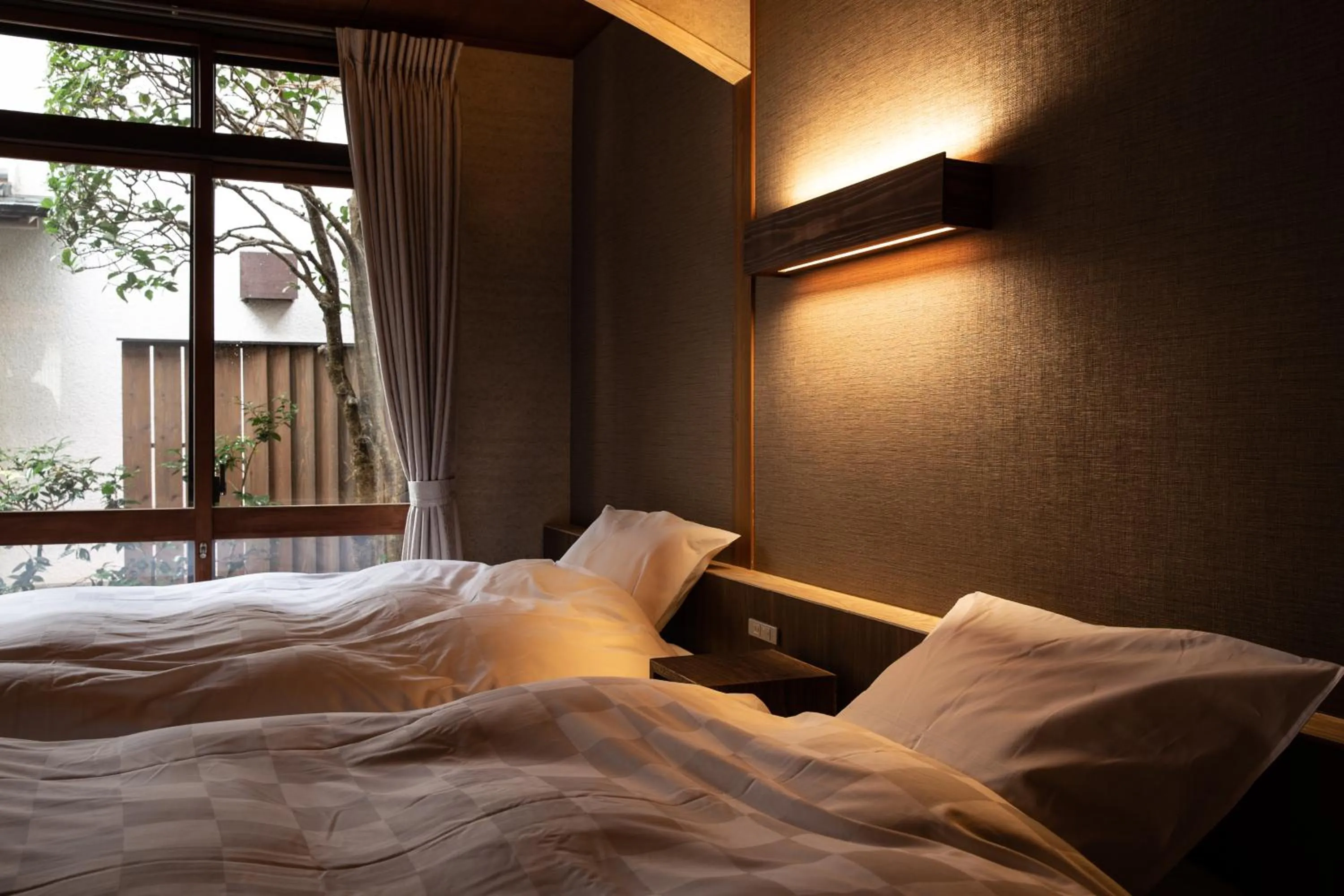 Bed in 城崎温泉 旅館 つばき乃 - Kinosaki Onsen Ryokan Tsubakino