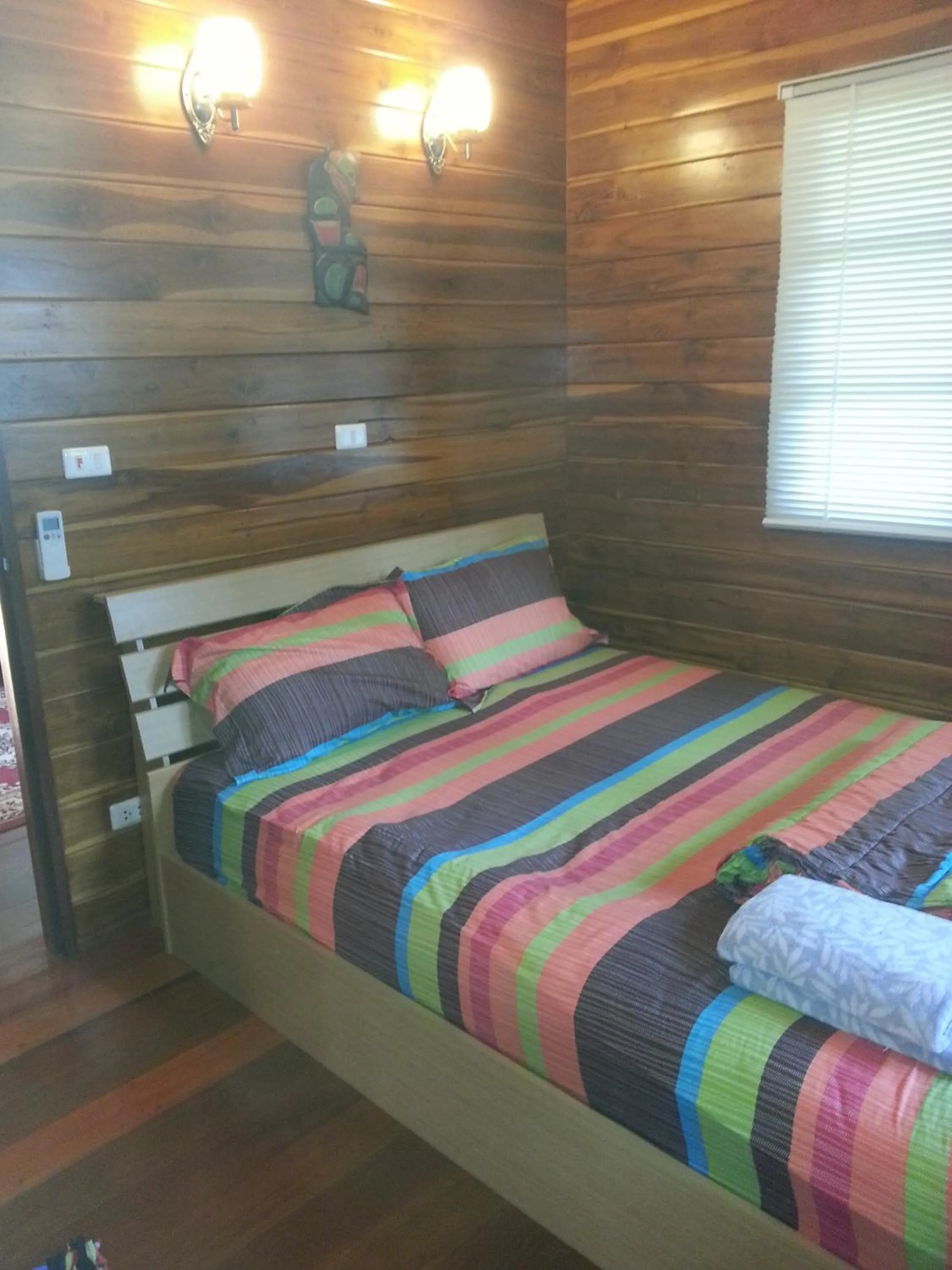Bed in Golden Teak Resort Baan Sapparot