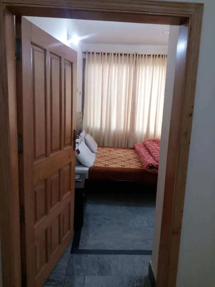 Bed in Kashmir Inn Hotel