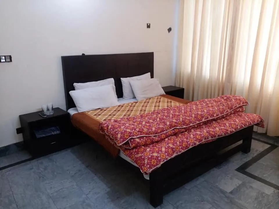 Bed in Kashmir Inn Hotel