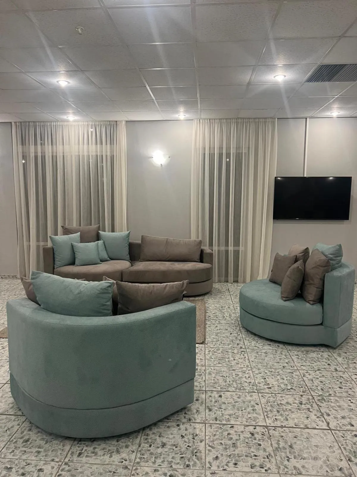 Communal lounge/ TV room in Ayit Hotel