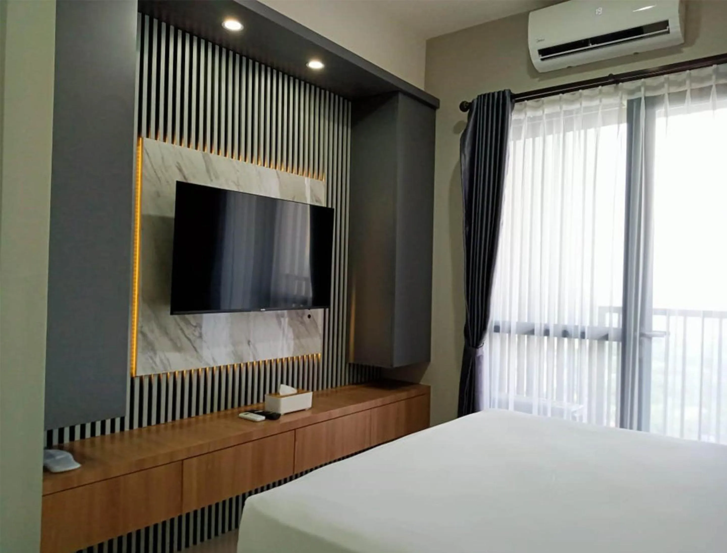 TV and multimedia, Bed in The Cozy Rooms at The Ayoma Residence, BSD Serpong