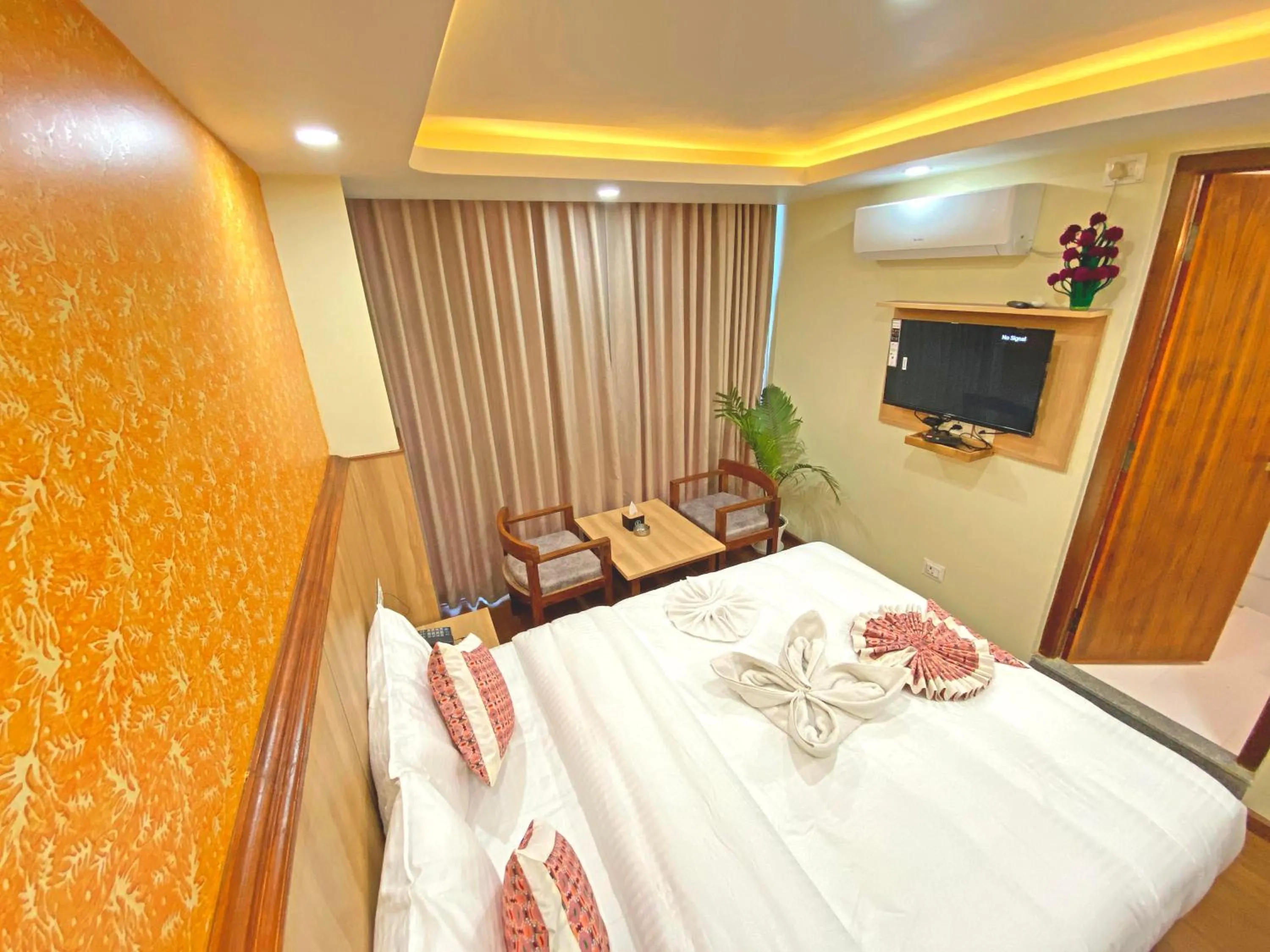 Communal lounge/ TV room, Bed in Hotel Lumbini Airport