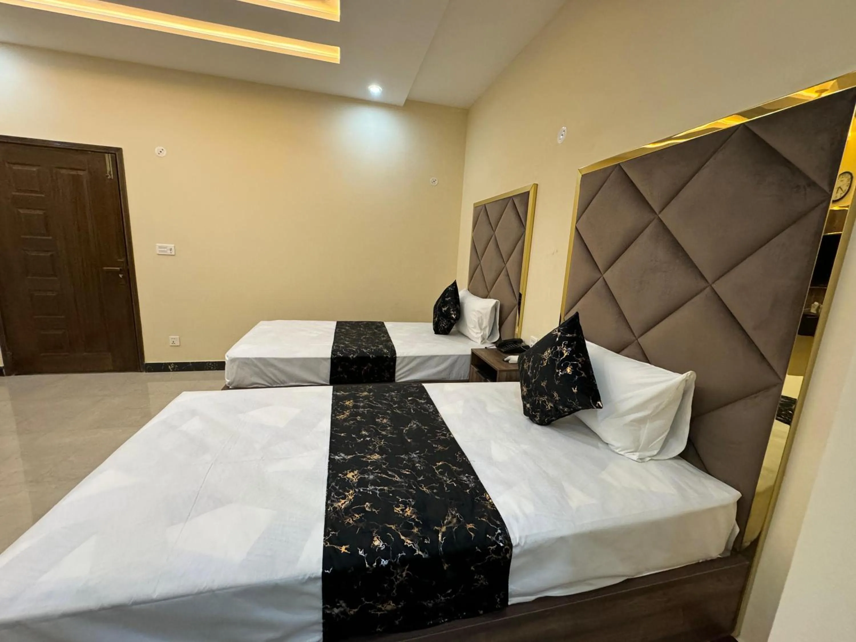 Photo of the whole room, Bed in Gold Pine Hotel Lahore